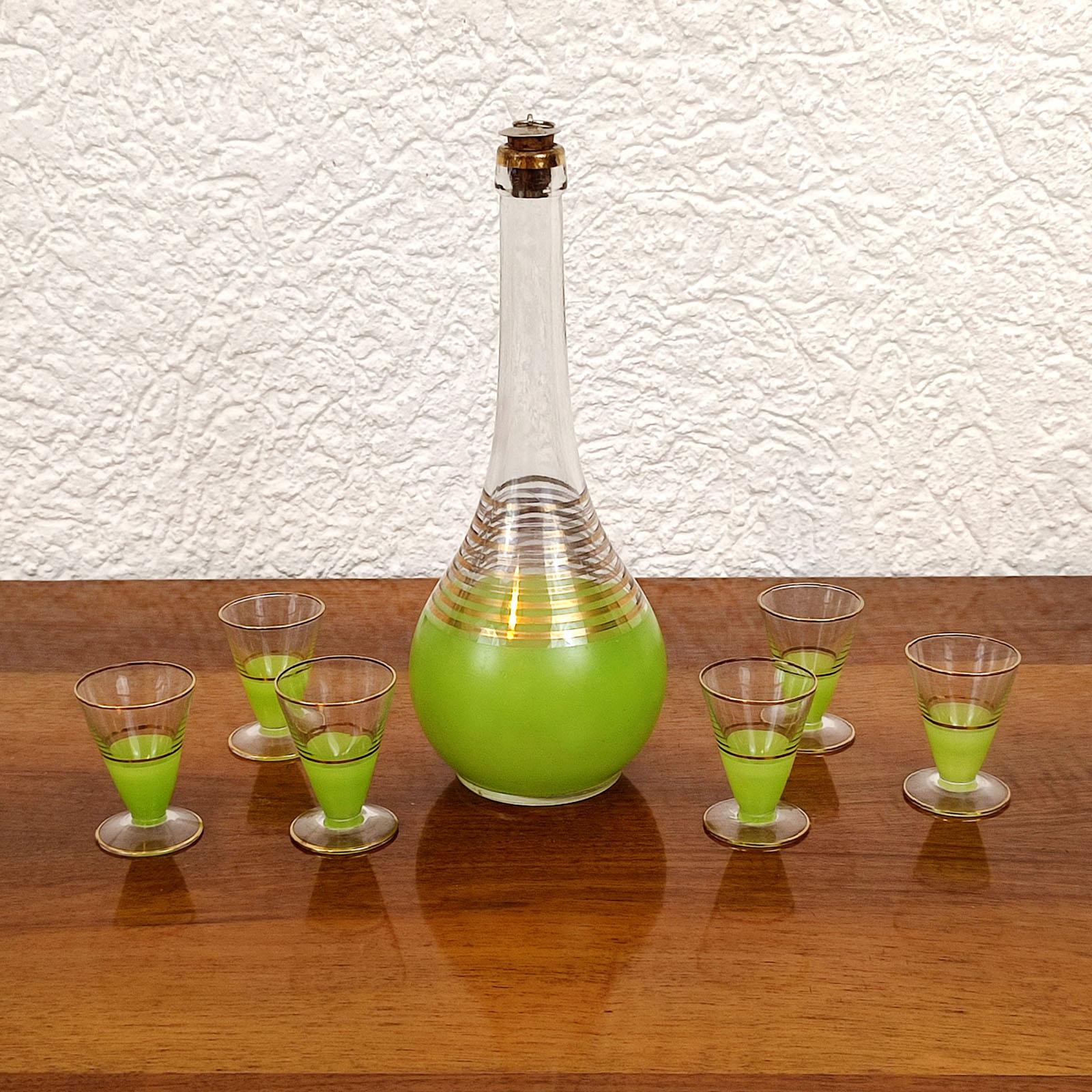 Italian glass decanter with 6 liquor glasses, originally made for a drink called Rosolio, but you could use it for which ever drink you like. Something where the light green color and gold accents of the glass come out the best we would say. In very