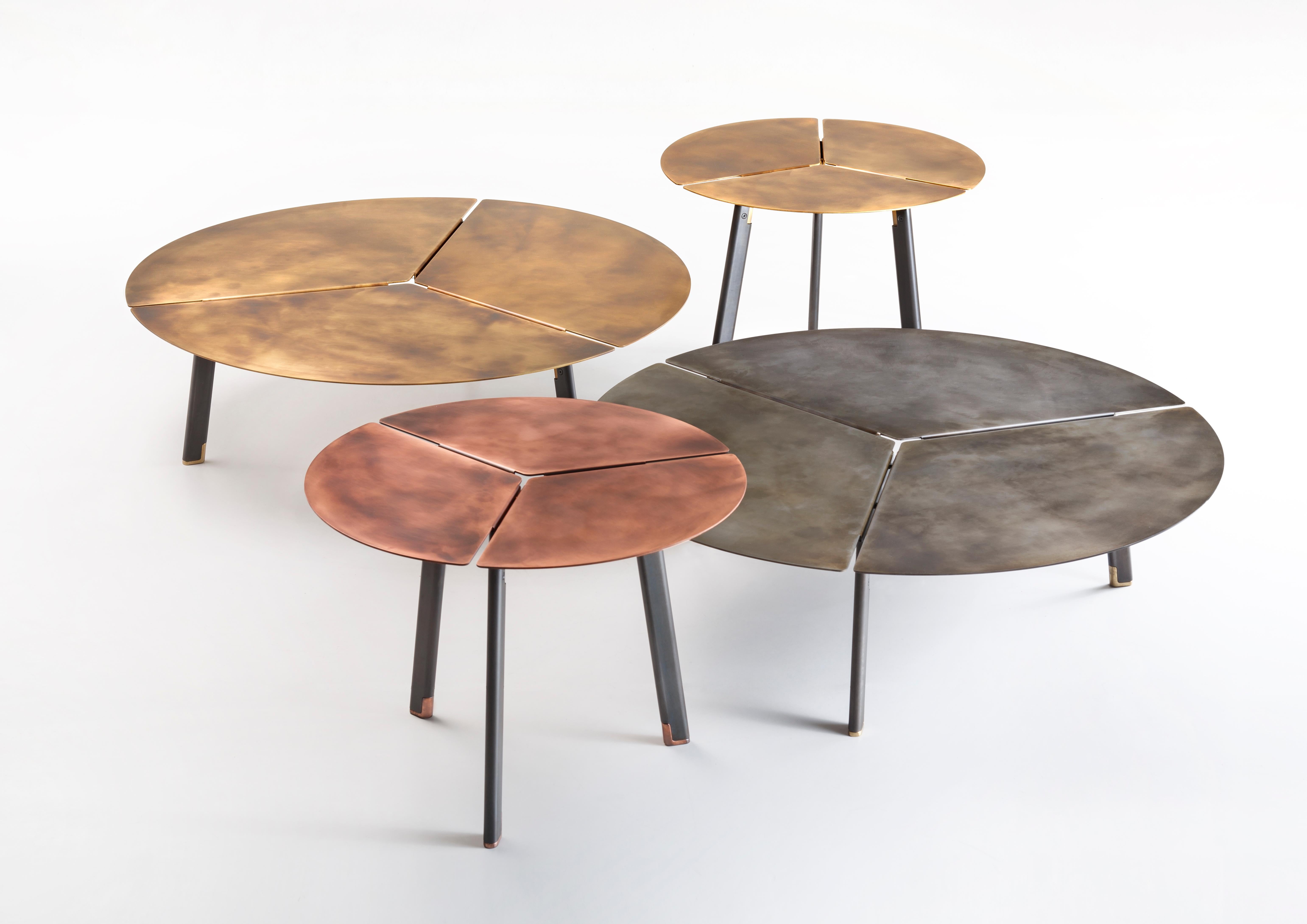 Three wedges, or three petals, open to create a circular table top, held together by the supporting frame of the legs. Simple yet effective design emphasizes the geometric nature of the design, highlighting the expressivity of the material, ennobled