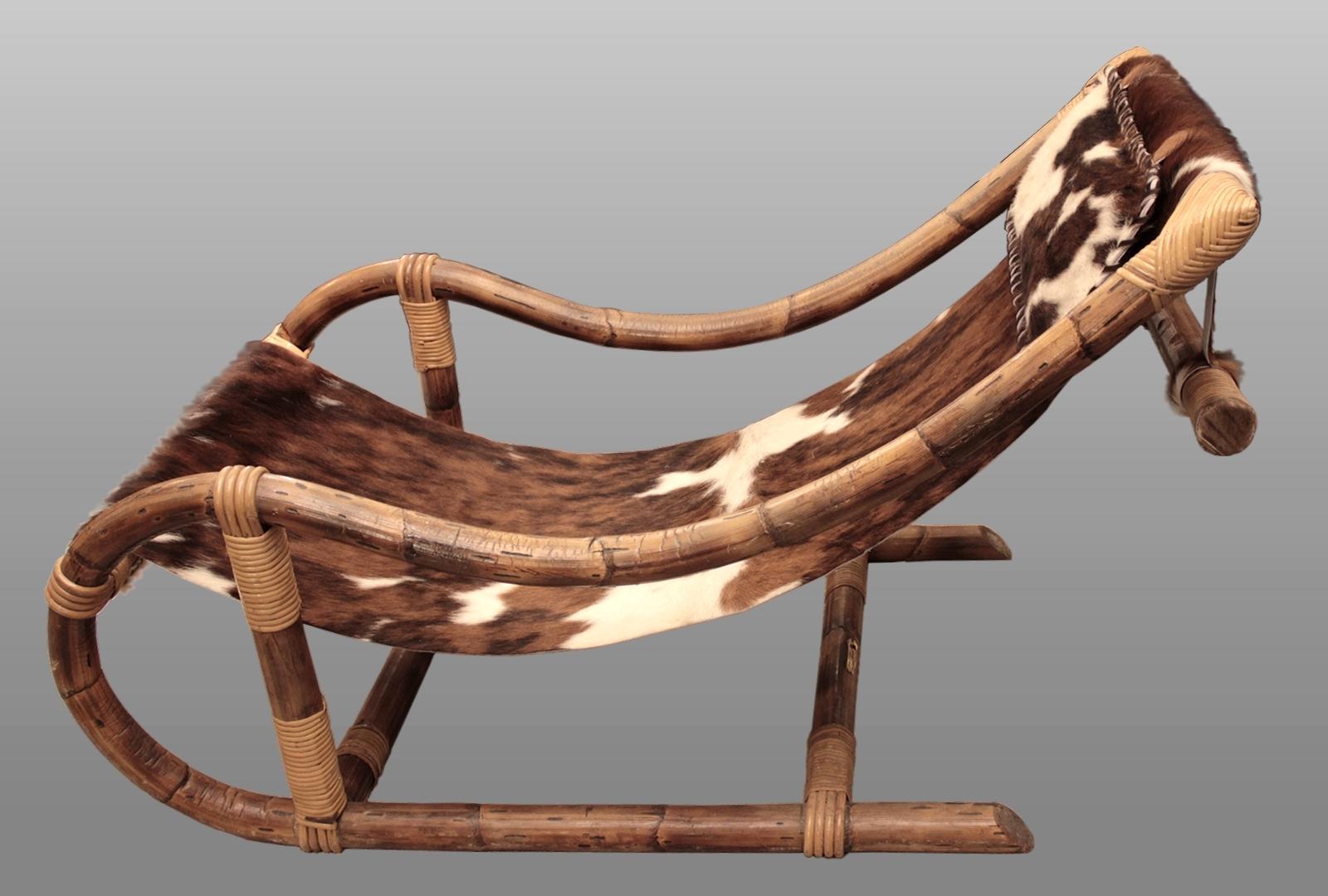 Lounge chair and footstool by Adrien Audoux and Frida Minnet
Golfe Juan, France, circa 1950.
Made of hot-formed bamboo and rattan, trimmed with natural cowhide

Armchair dimensions:
Length 44.88 in
Width 24.41 in
Seat depth 26.4 in
Backrest