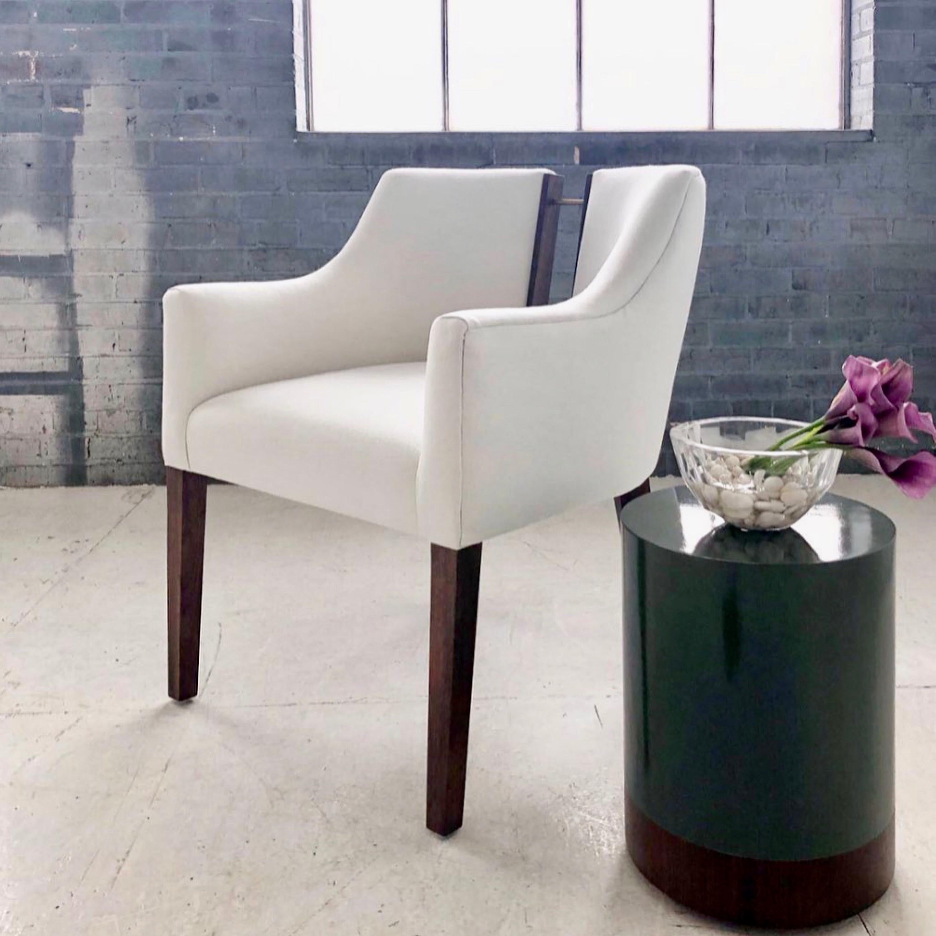 
Our Declan dining chair exudes sophisticated elegance. It is sleek and curvaceous, with the perfectly unexpected walnut and brass back detailing. A modern chair with Classic proportions. Pictured here in solid walnut, darkened brass and upholstered