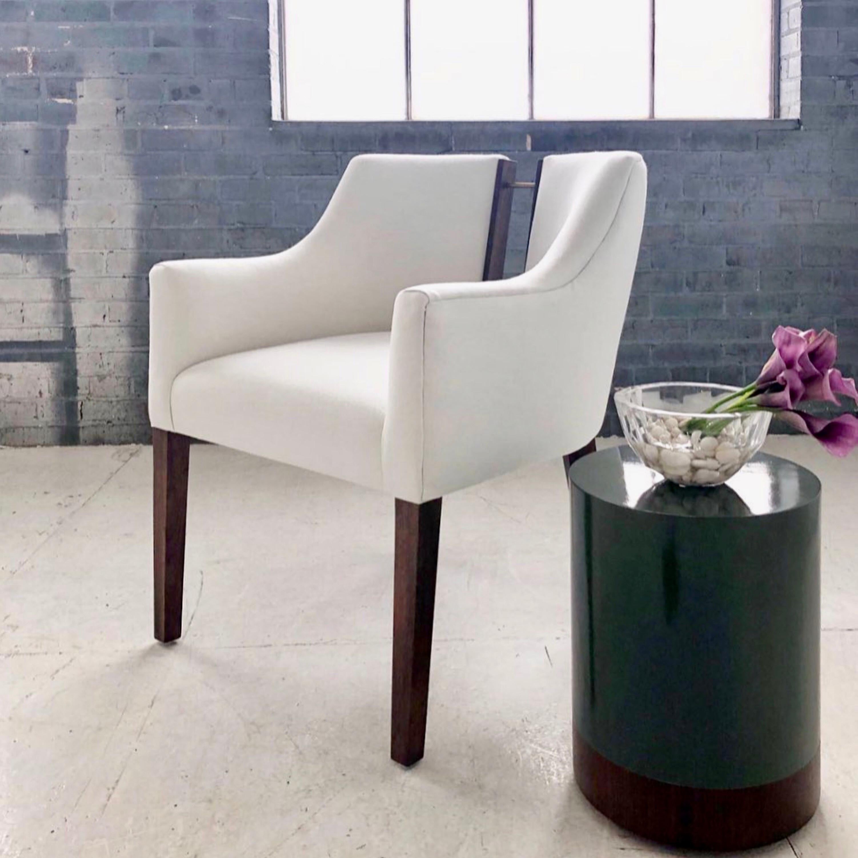 Our Declan dining chair exudes sophisticated elegance. It is sleek and curvaceous, with the perfectly unexpected walnut and brass back detailing. A modern chair with Classic proportions. Pictured here in solid walnut, darkened brass and upholstered