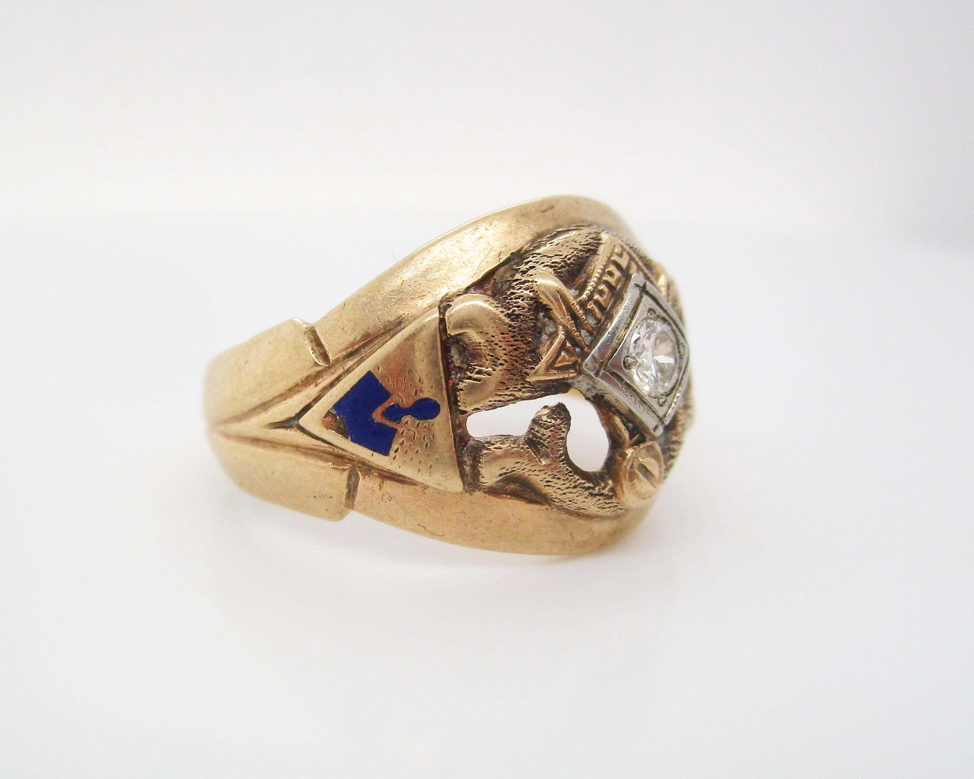 This awesome men’s ring is in 10k yellow gold and features a great cut-out design completed by enamel accents and a bright white diamond set in the center. 
This great ring has an excellent weight to it that makes it the ideal men’s accessory. 
This