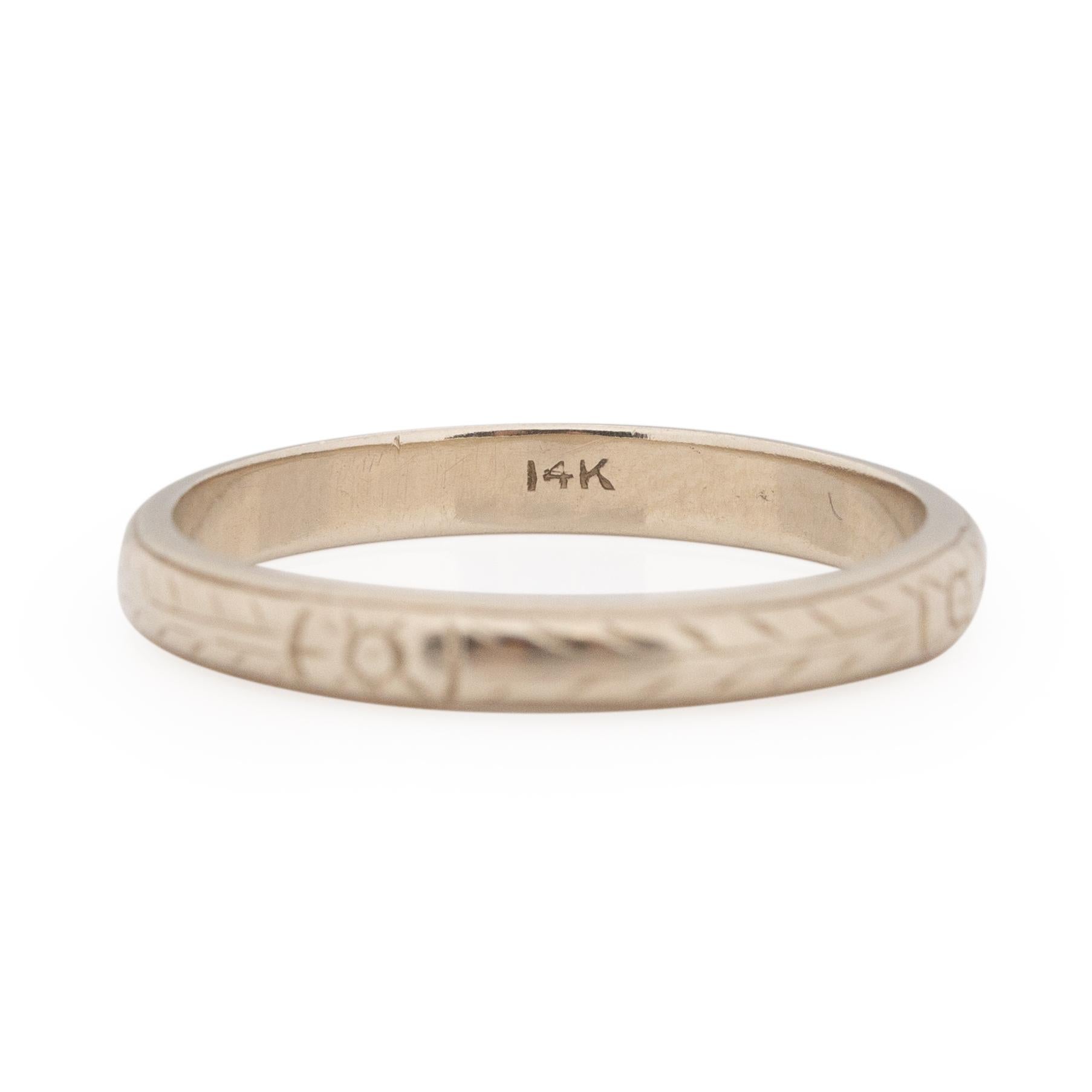 This little floral engraved beauty is a fun little pop of engraving, but still subtle and elegant. This ring is crafted in 14K white gold, the paleness of the white gold is a wonderful compliment to the delicate floral and braded engraving. This