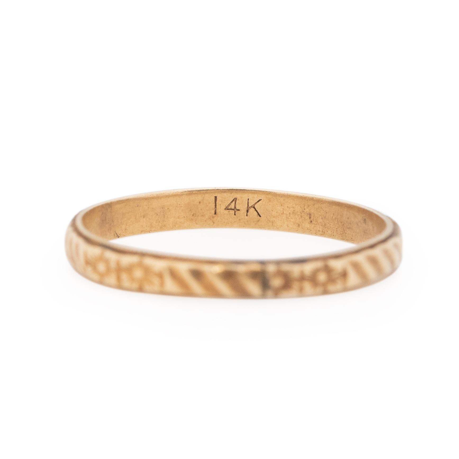 This delicate beauty has an elegant floral and line designed repeating pattern that encompasses the entire ring. Crafted in 14K yellow gold this band is in great condition for its age, and has many more years to give. This ring is suited for either