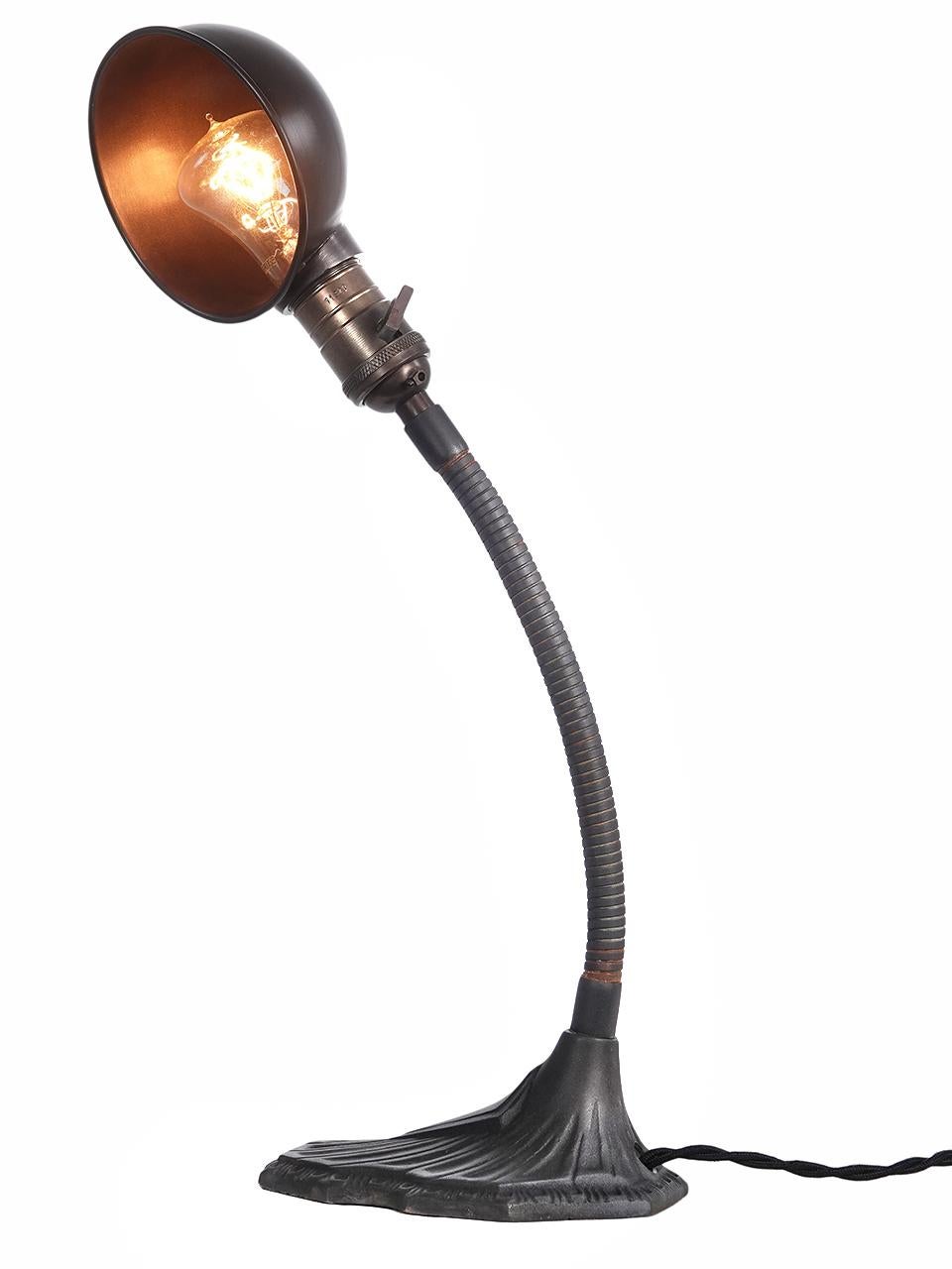 This is a nice size desk lamp. Not too big so it takes over the desk. The line are clean and simple with a gooseneck arm, deco style molded cast iron base and a brass shade. We rewired the lamp with an antique style black fabric covered twisted
