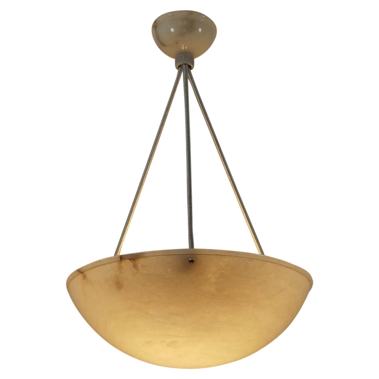 A highly mineralized alabaster shade has been carved into a bowl with rim shape and a matching ceiling canopy.