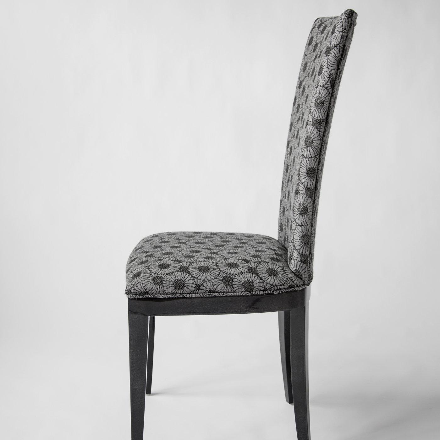 An exquisite example of designer seating, the Deco Chair has an elegant and sophisticated structure covered with gloss anthracite gray parchment and features a padded seat and back upholstered in vintage fabric. The captivating design will