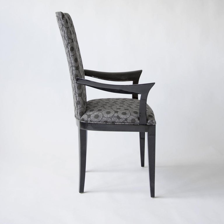 The Deco chair is an exquisite example of designer seating, featuring an elegant and sophisticated structure covered with gloss anthracite gray parchment and a padded seat and back upholstered in vintage fabric. Complete with armrests, it will