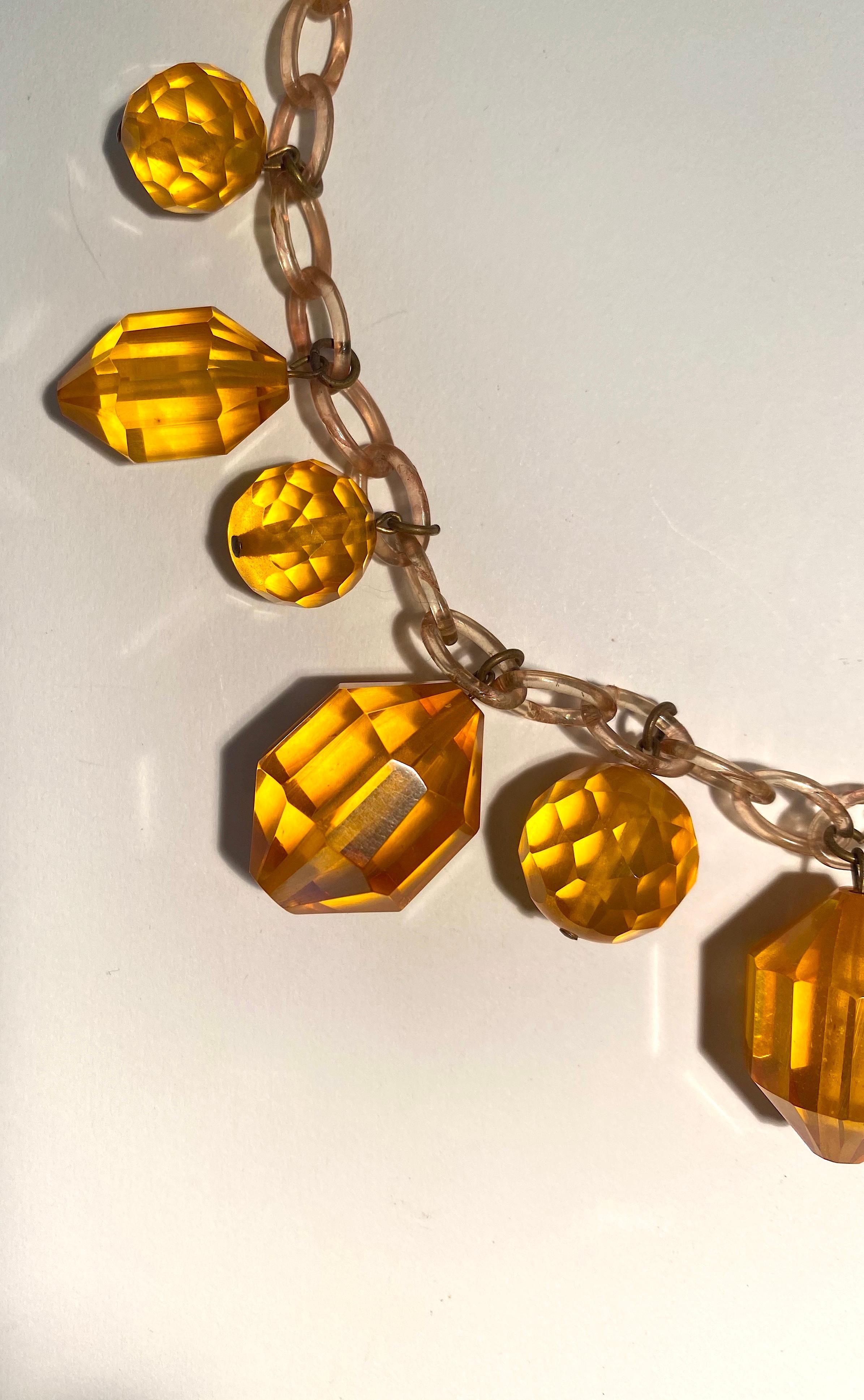 Fabulous Vintage bakelite piece in a yellow amber color on a topaz bakelite chain.  Great movement when you wear this incredible design of multi faceted chunky pieces.  Unsigned.  Color varies depending upon the light on the necklace.  I have had
