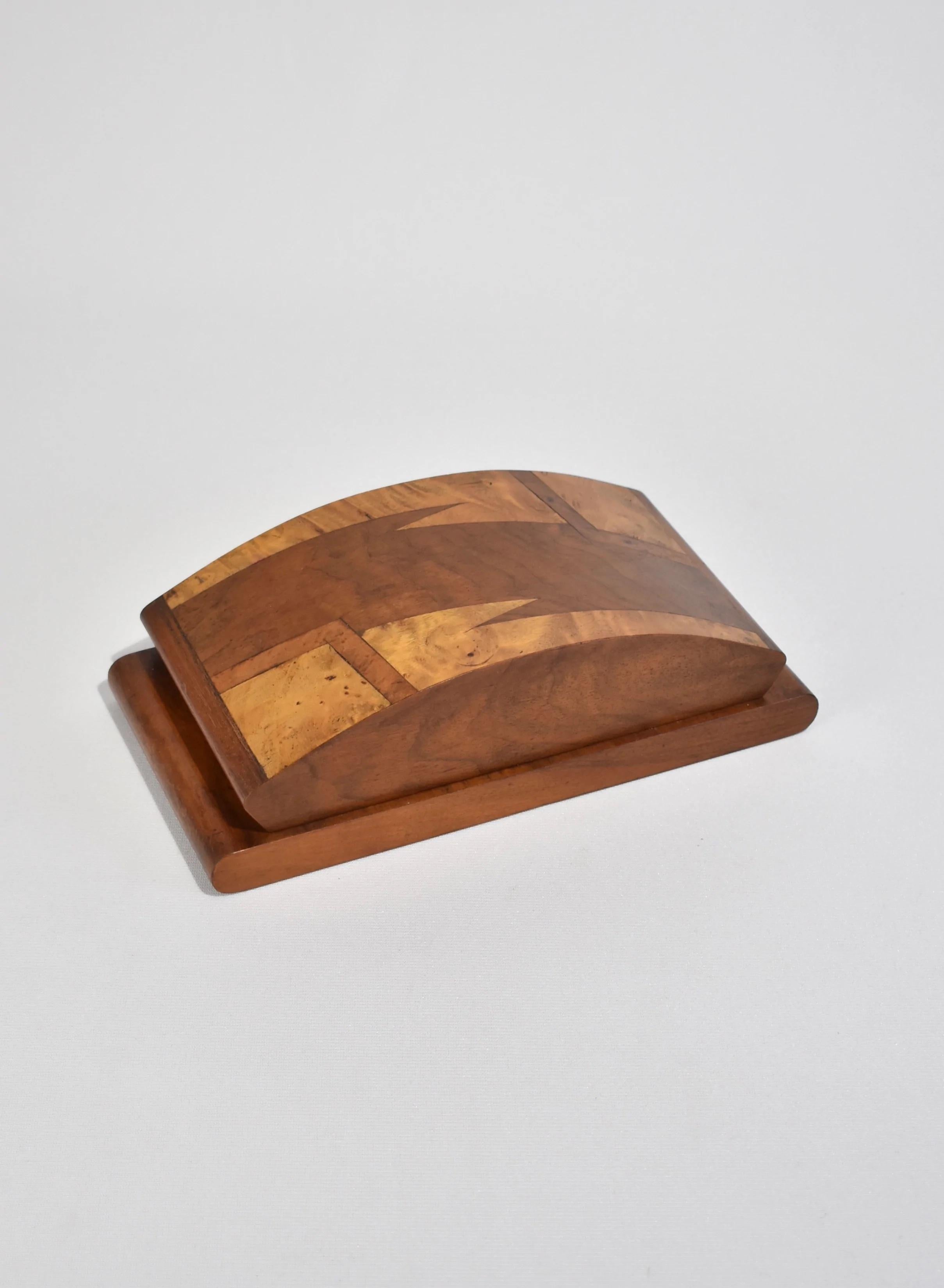 Rare, art deco wooden cigarette box. Hinged interior features three rows with ten slots each for cigarettes.