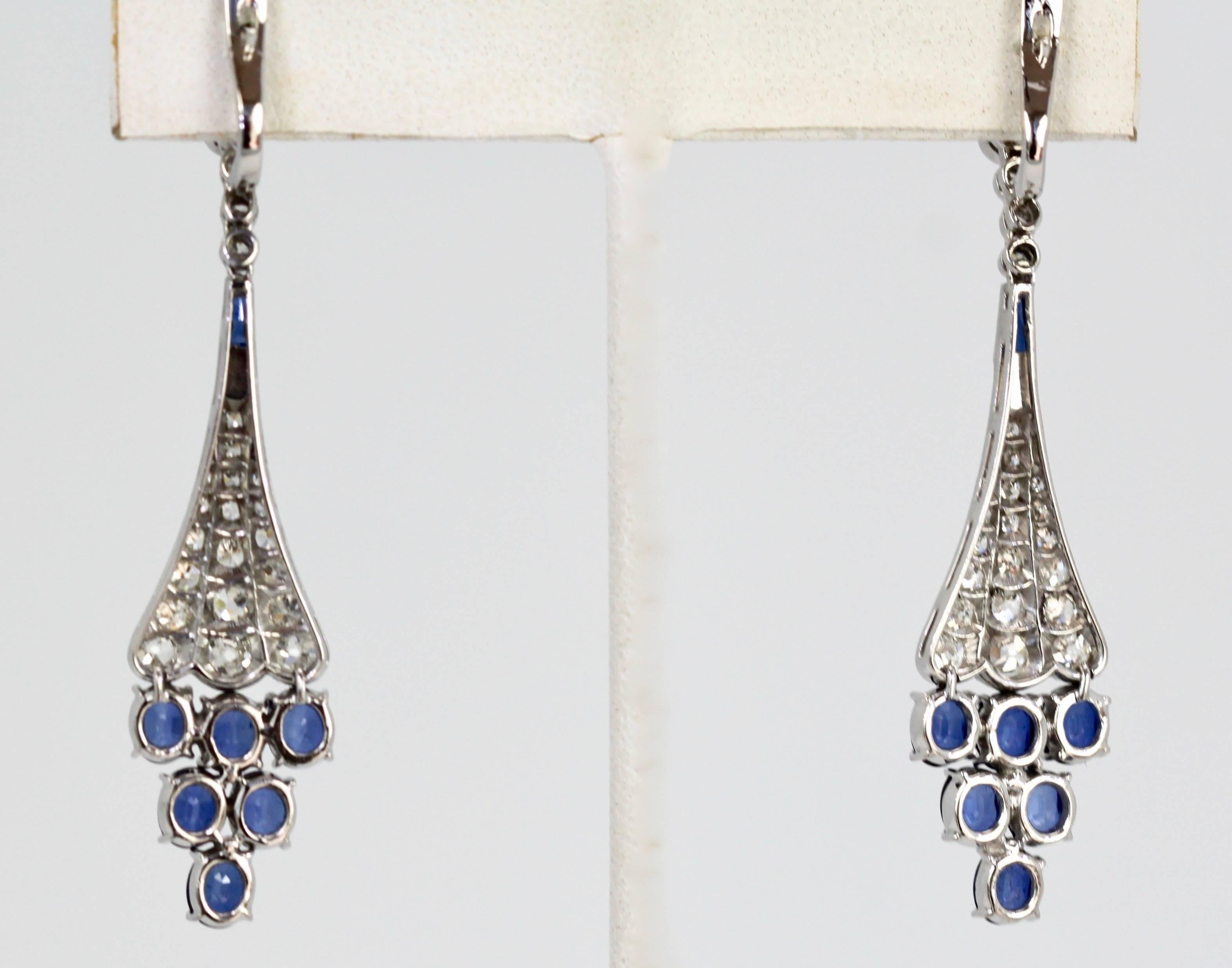 These Diamond Sapphire drop earrings are beautiful.  The oval cut Sapphires have a color grade of light purplish Blue.  The carat weight of the Sapphires are 4.66 carats. The diamonds have a clarity of VS2 - SI1 and color grade of F-G and the weight