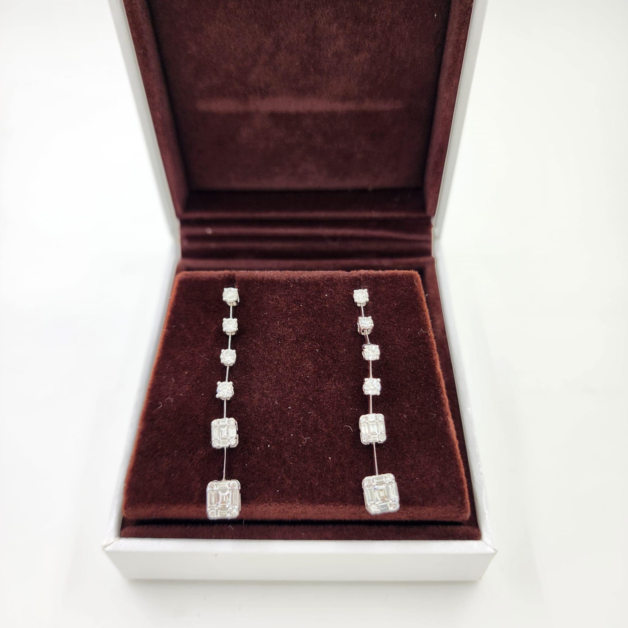 Elevate your jewelry collection with these stunningly crafted drop earrings, a masterpiece of design and luxury. Each earring features a delicate chain of lustrous white round diamonds, totaling 0.81 carats, set in a harmonious sequence that