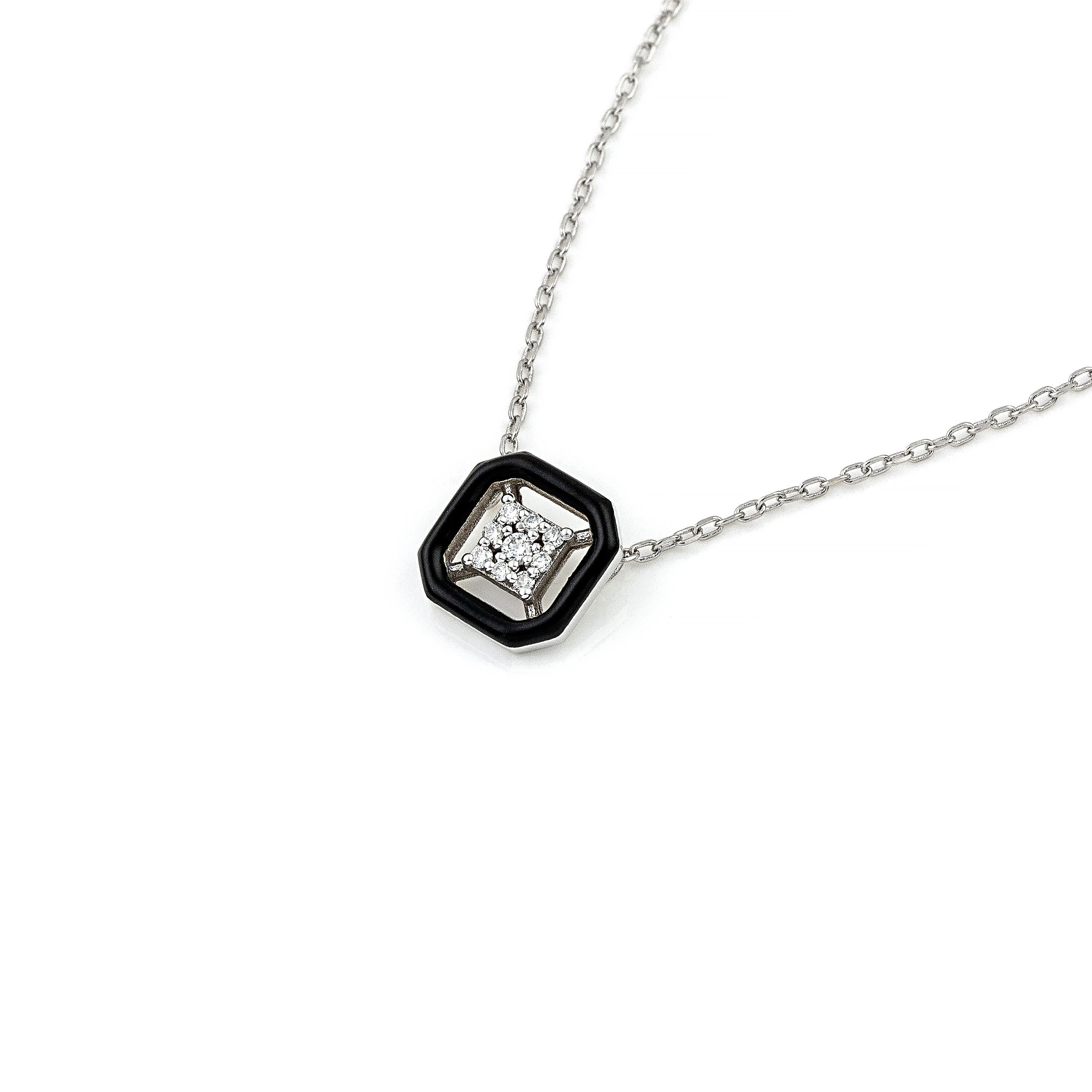 14K gold diamond pendant necklace with a classic black colour accent, the perfect gift for yourself or a loved one.
100% Recycled 14 K White Gold
Diamonds
Black Enamel
Size: 1.3 cm/0.51 inches
Inspiration: In the arts, maximalism, a reaction against