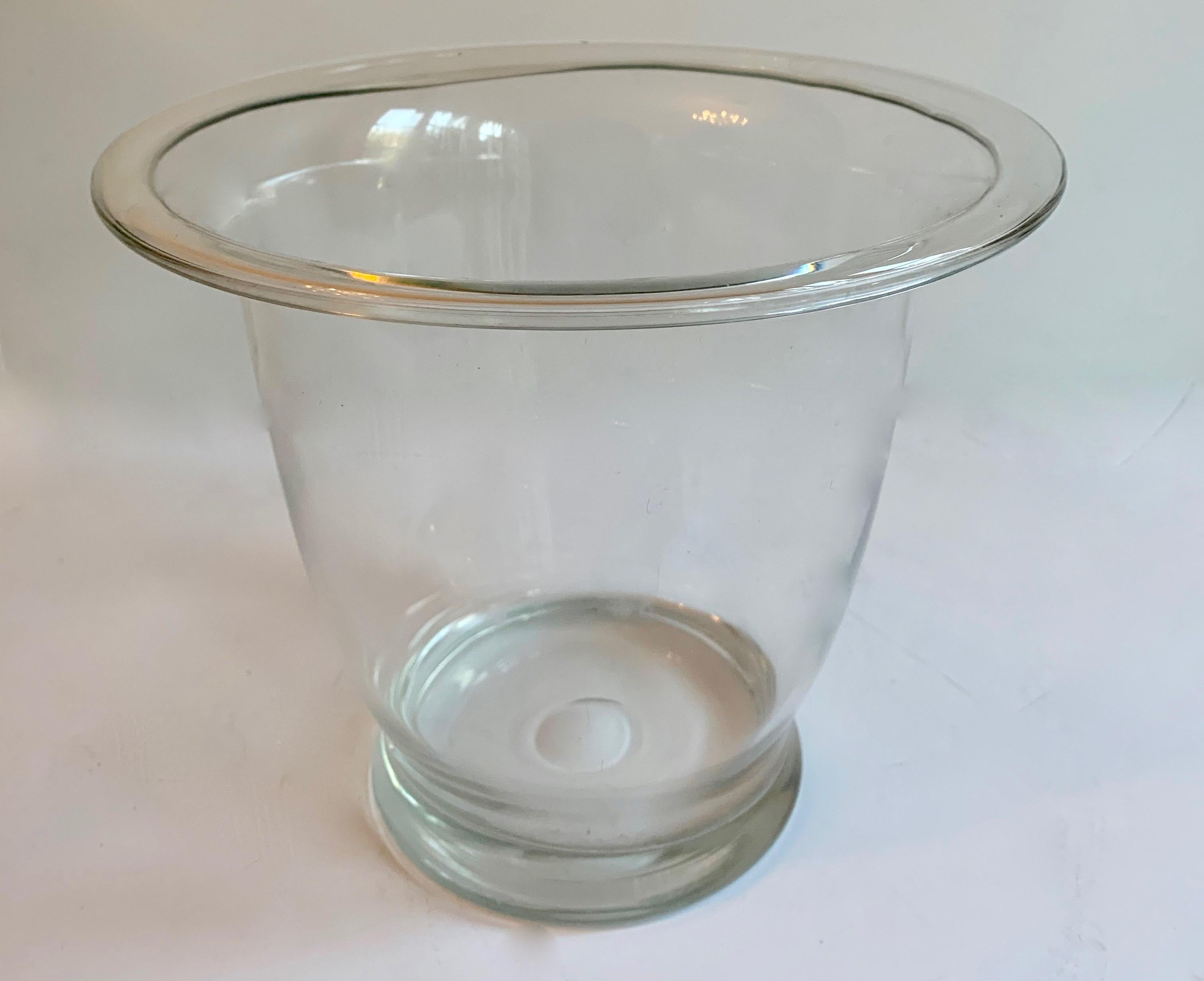 A wonderful deco ice bucket with raised handles. The piece is made of newly polished aluminum and looks wonderful. On the reverse side please not the areas that were divers from age that could not be polished. 

The piece has a glass liner for