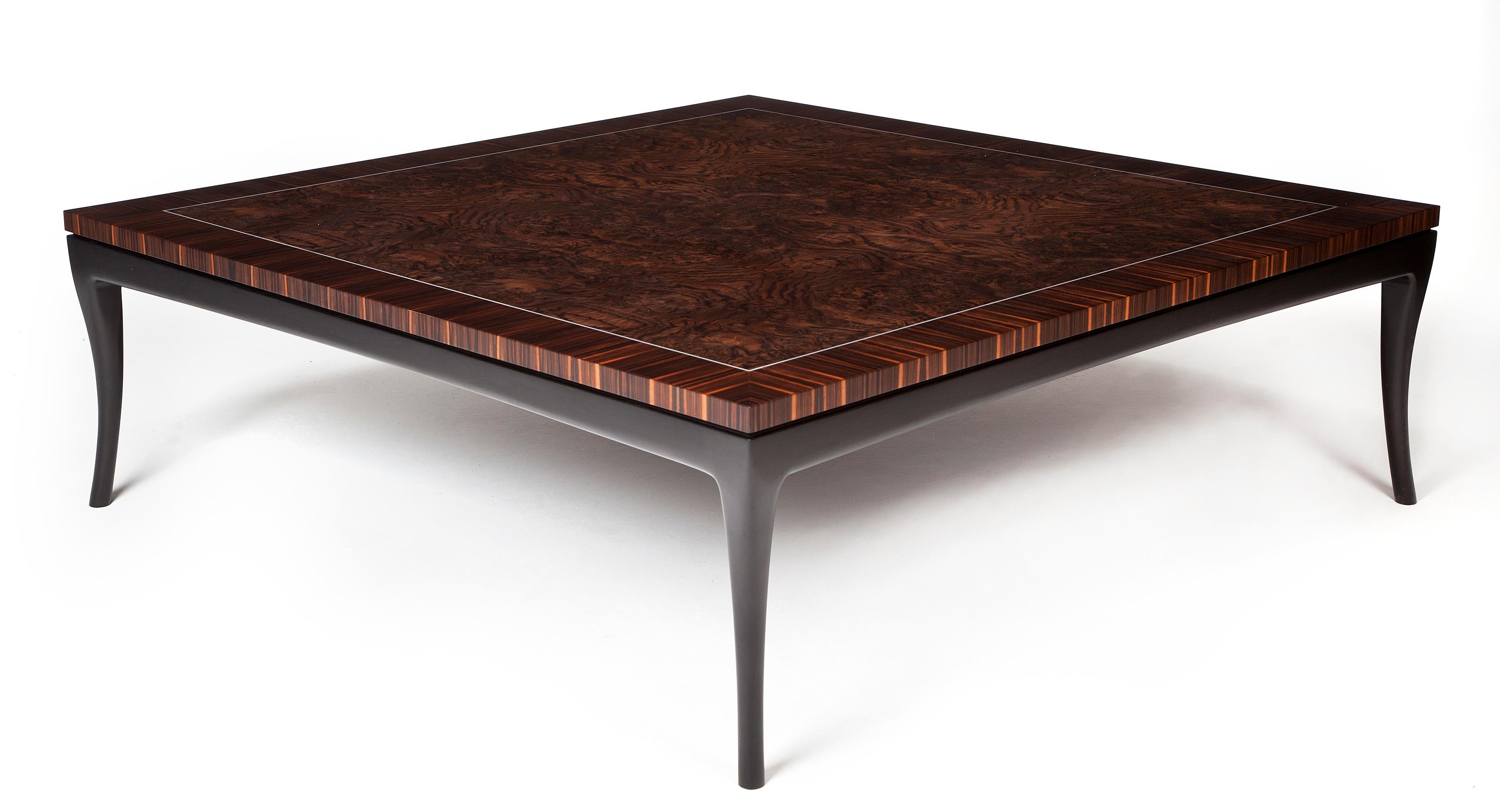 Deco-inspired large and modern coffee table in Macassar ebony and burr walnut with a white metal inlay. The tabletop sits on a blackened frame with elegantly carved black legs.

Originally designed for clients with Art Deco interior styling, along