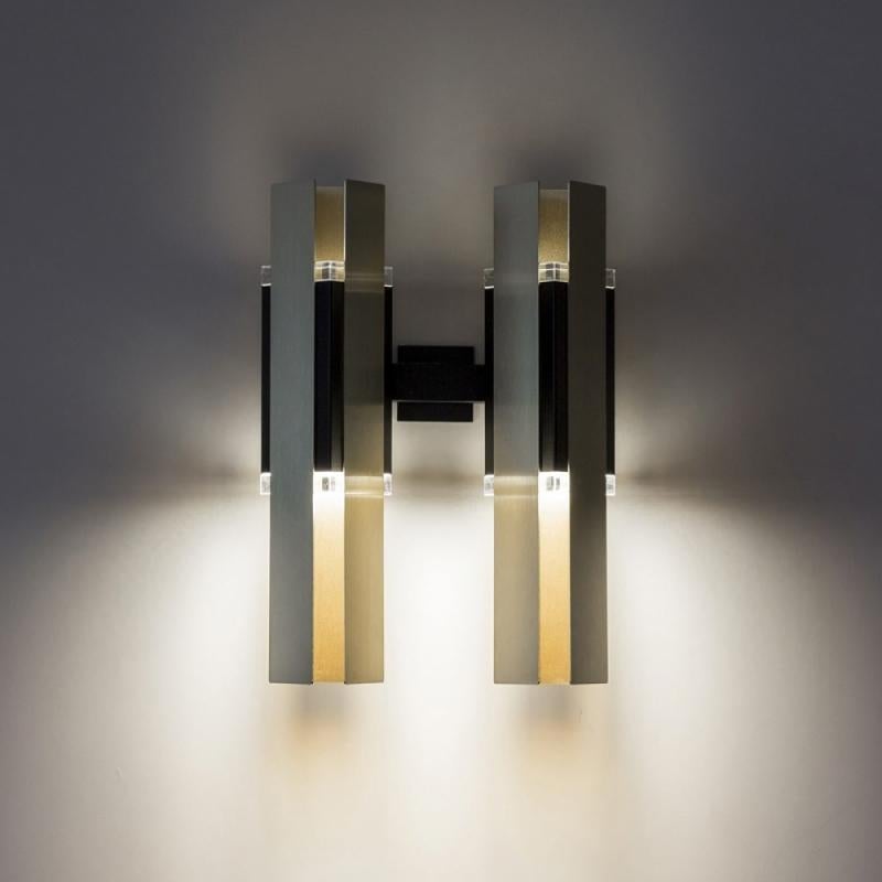 Code 559.42 
A slightly deco inspired hanging lamp with a triangular base. The main body is in black coating and the light is spread through 2 plexiglass prisms and it’s wrapped into 3 rectangular brushed brass foils. It is available in different