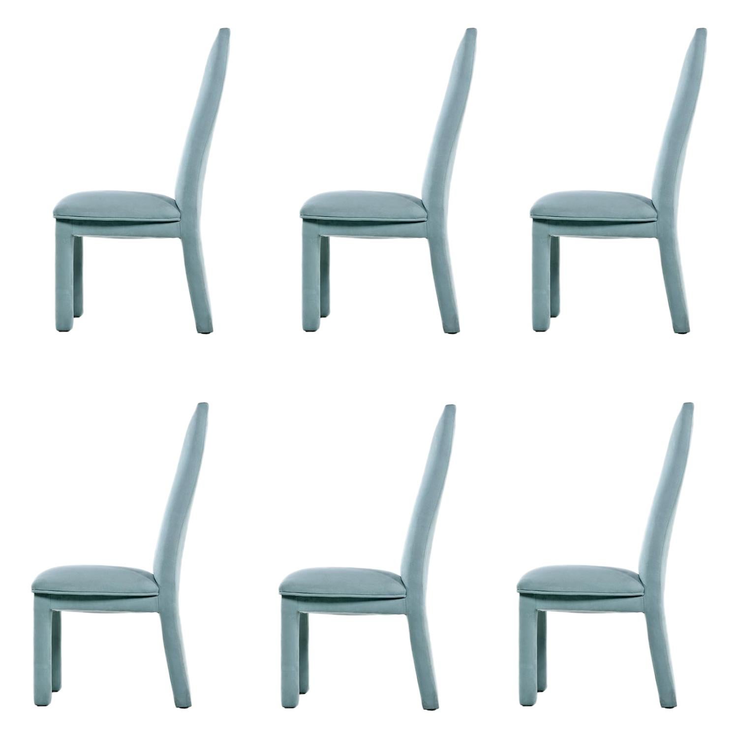 Set of six vintage high-back dining chairs updated with aqua blue microfiber upholstery. The chairs are ultra modern but exude an air of comfort with the plush fabric and amply padded form. The sharp angles of the Art Deco inspired silhouette are