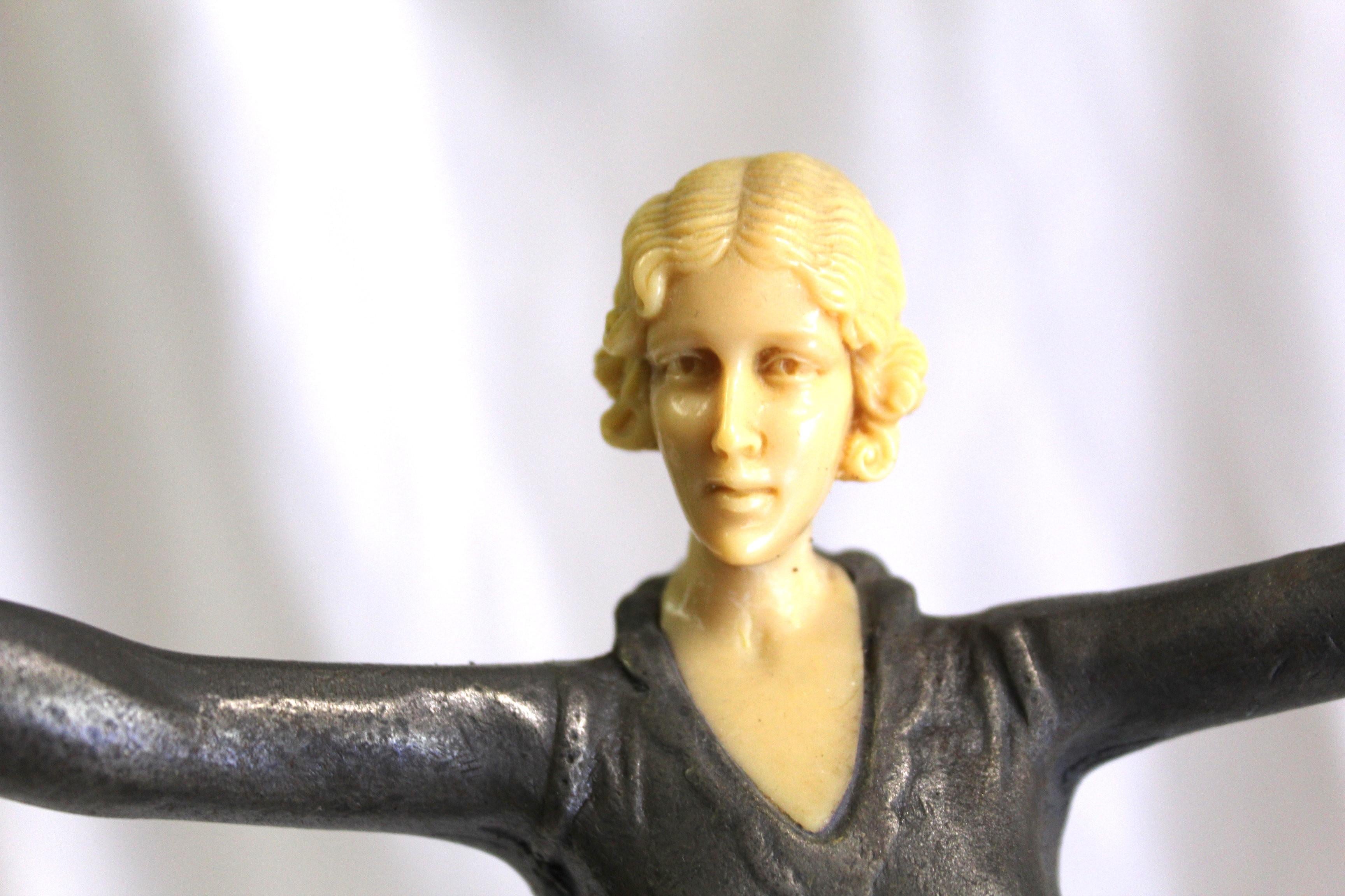 An elegant pose of a Lady figurine with out streached arms . Casting is metal with bronze finish , Total ht is at 14