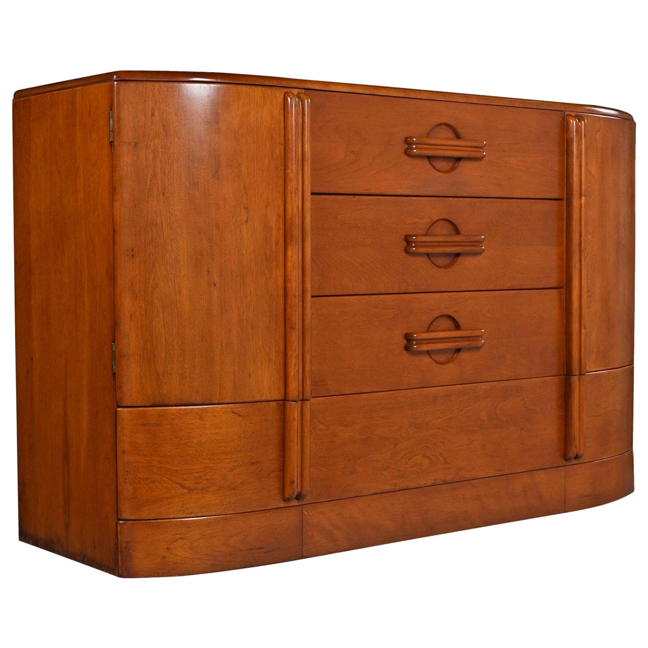 The C3318 Airflow buffet was designed by Heywood Wakefield and 1937 and continued production until 1939. Distinct 1930s styling is evident in the blending of Art Deco and machine age motifs on the drawer pulls. The solid maple wood buffet has stood