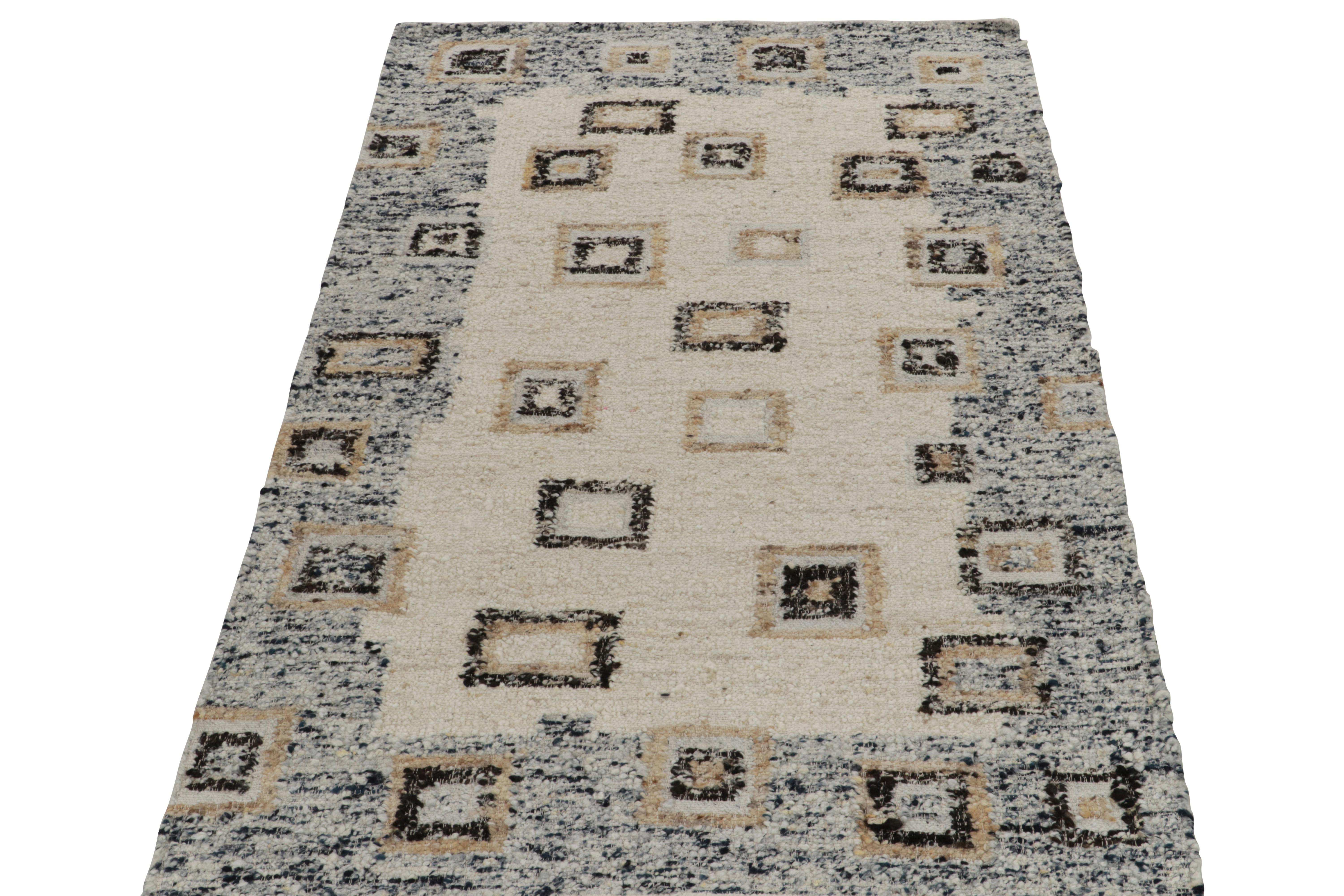 Rug & Kilim unveils an innovative 5x8 flat weave rug connoting a unique marriage of Deco style and bold texture. The rug features a modern geometric pattern in crisp white, beige-brown, and black & with a blue border—all manifested by handspinning a