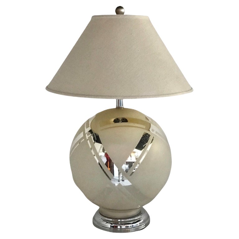 Deco Revival late 1970s mirror glass table lamp. Art Deco inspired round table lamp with crisscrossed band of mirrored glass with a frosted flat off-white applied paint and newly chromed hardware. Rewired with UL solid brass (chromed) 3-way socket