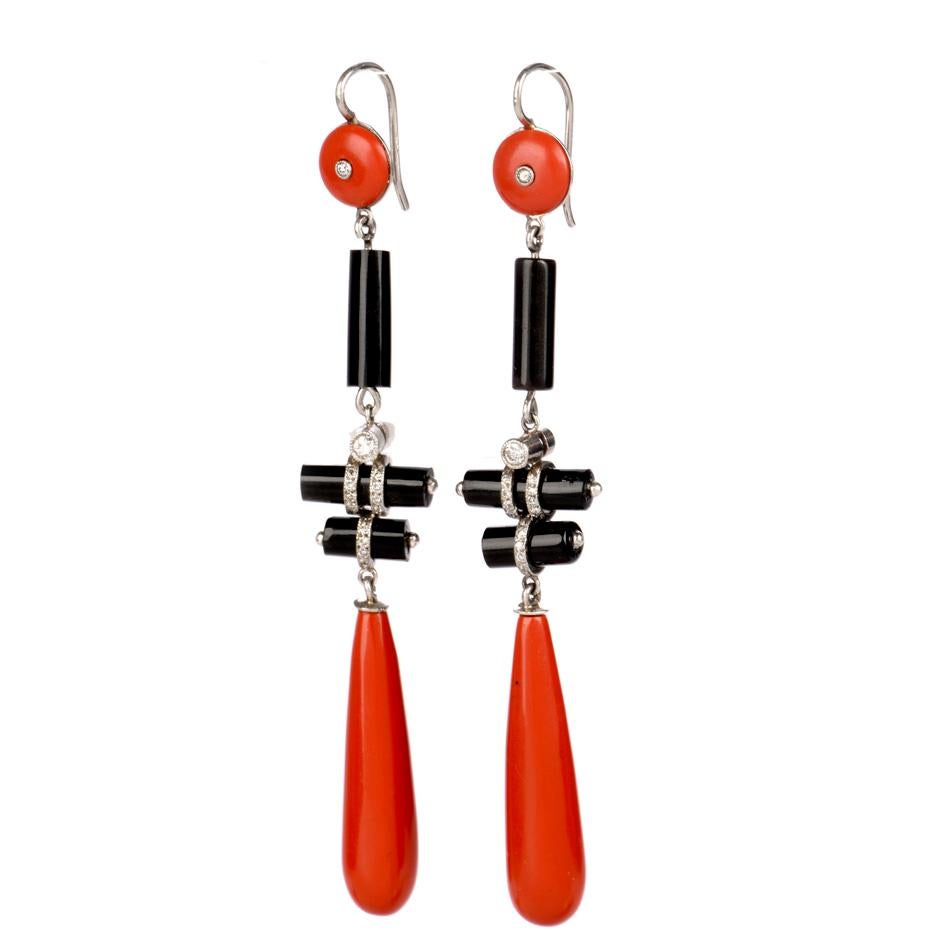  These estylish earrings are crafted in solid platinum, weighing 10.7 grams and measuring 3” long x 15mm wide. Composed 6-cylinder shaped onyx beads, a pair of circular coral colored enamel and a pair of elongated oval coral colored enamel all