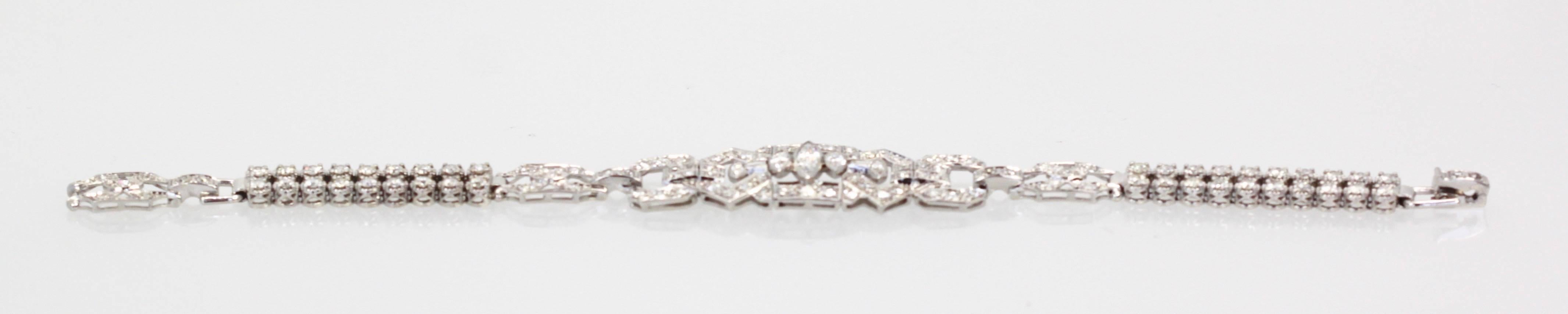 This Platinum bracelet was made during the 1920's and it is impressive. The front center plaque is 4.5cm L x 1.5cm W.  It is filled with marquise Diamonds the center being 0.62 Carats there are two smaller plaques on each side of the center and this