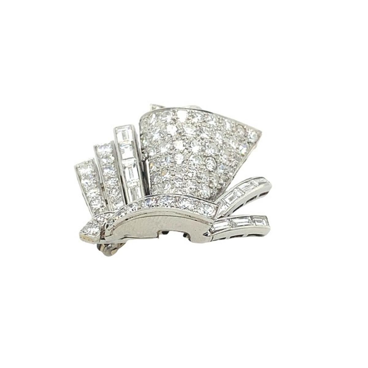Deco Platinum Brooch Set With 1.0ct of F/VS Baguette + 1.5ct of Round Diamonds.

Additional Information:
Total Weight: 12.1g
Total Diamond Weight: 2.50ct
Diamond Colour: E/G
Diamond Purity: VS
Brooch Size: 27mm x 27mm
SMS5263