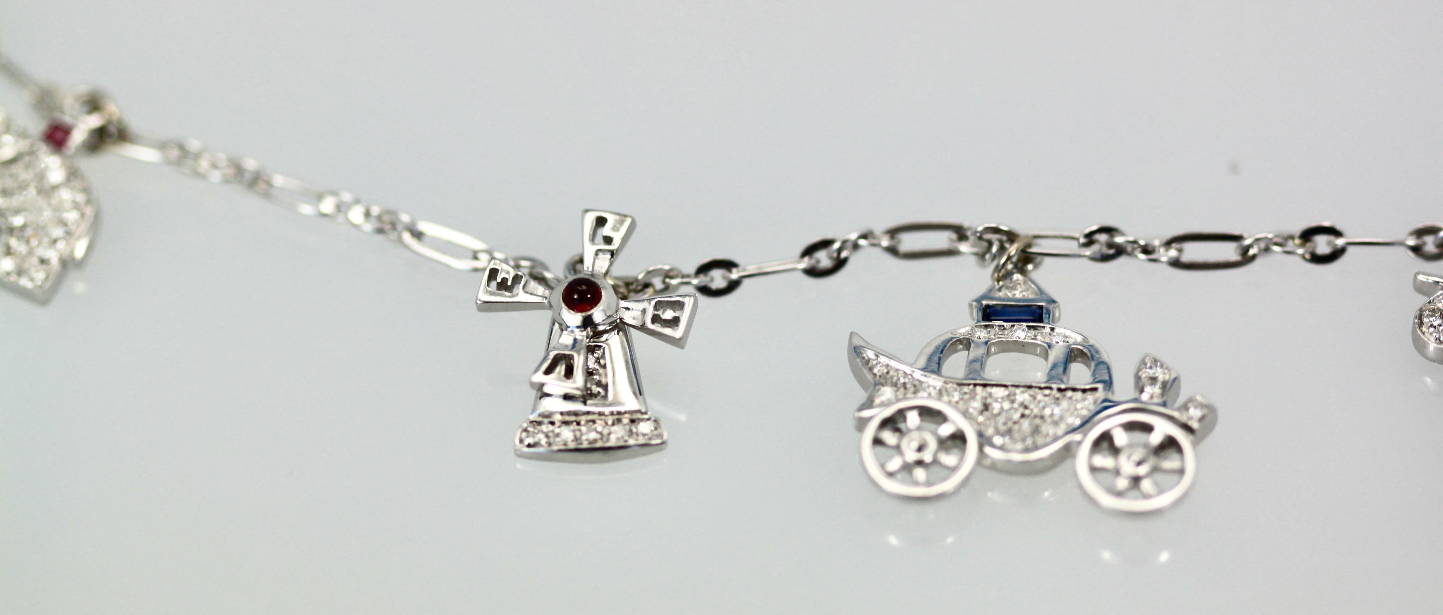 This gorgeous Deco Platinum charm necklace holds 5 unique Platinum charms:  A Horse with rider, an Elephant, a Hobo, A carriage, and a windmill with rotating veins. There are Diamonds and gemstones on these charms.  This comes out of Austria and is