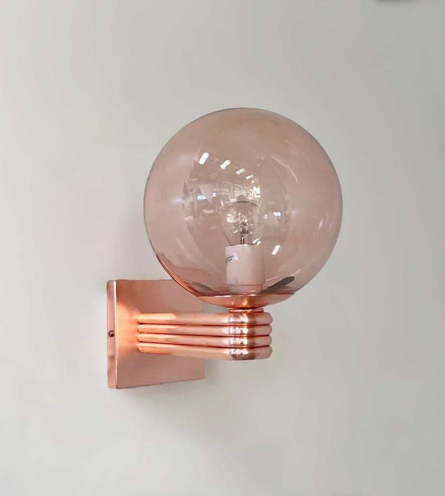 Aplique de pared italiano de estilo Art Déco con globo de cristal de Murano coralino rosa transparente montado en un marco de acabado cobre satinado, diseñado por Fabio Bergomi para Fabio Ltd, fabricado en Italia
1 luz / tipo E12 o E14 / máx.