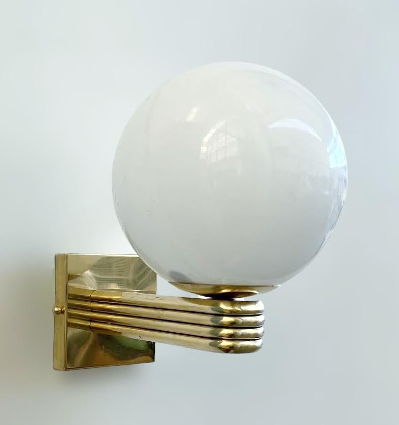 Italian Art Deco style wall light with glossy white Murano glass globe mounted on unlacquered natural brass frame, designed by Fabio Bergomi for Fabio Ltd, made in Italy
1 light / E12 or E14 type / max 40W
Measures: Height 12 inches, width 8 inches,