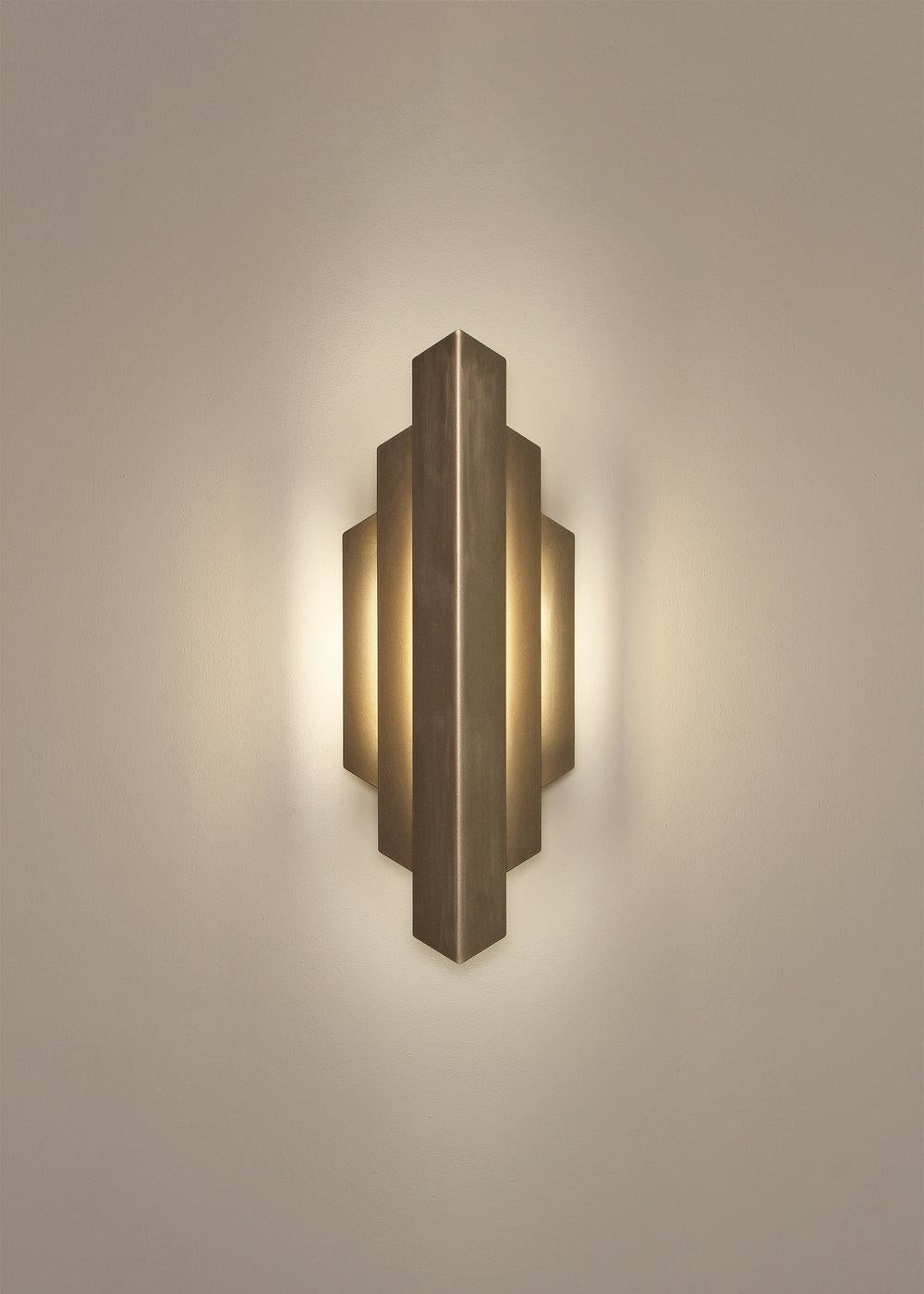 DECO SCONCE washes the wall with a gentle glow of indirect light. Its striking form was inspired by the bold, geometric lines that defined the Art Deco movement. Deco Sconce provides a soft, accent illumination for a hallway or feature wall.

Metal