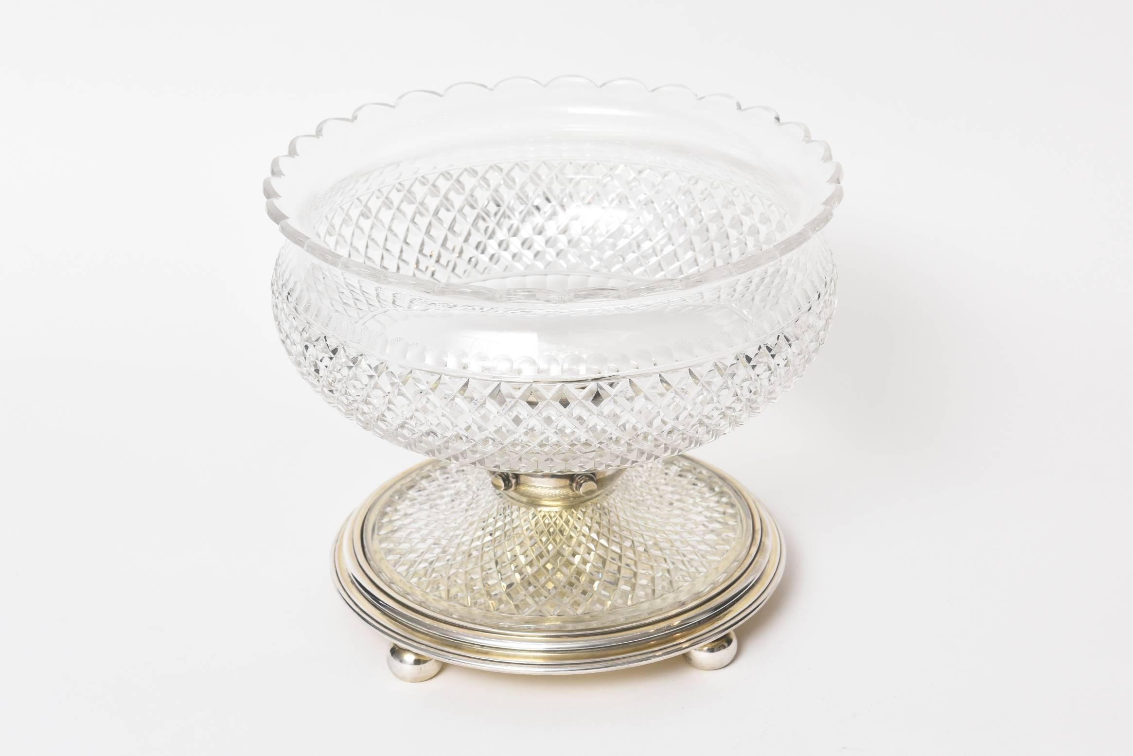 Silver plate with beautiful criss-cross cut-glass piece with scapploed edge on one side and finger tip presses on top and bottom of criss-cross pattern bowl. The bottom glass section has graduated crisscross patter. One ball of the four ball feet is