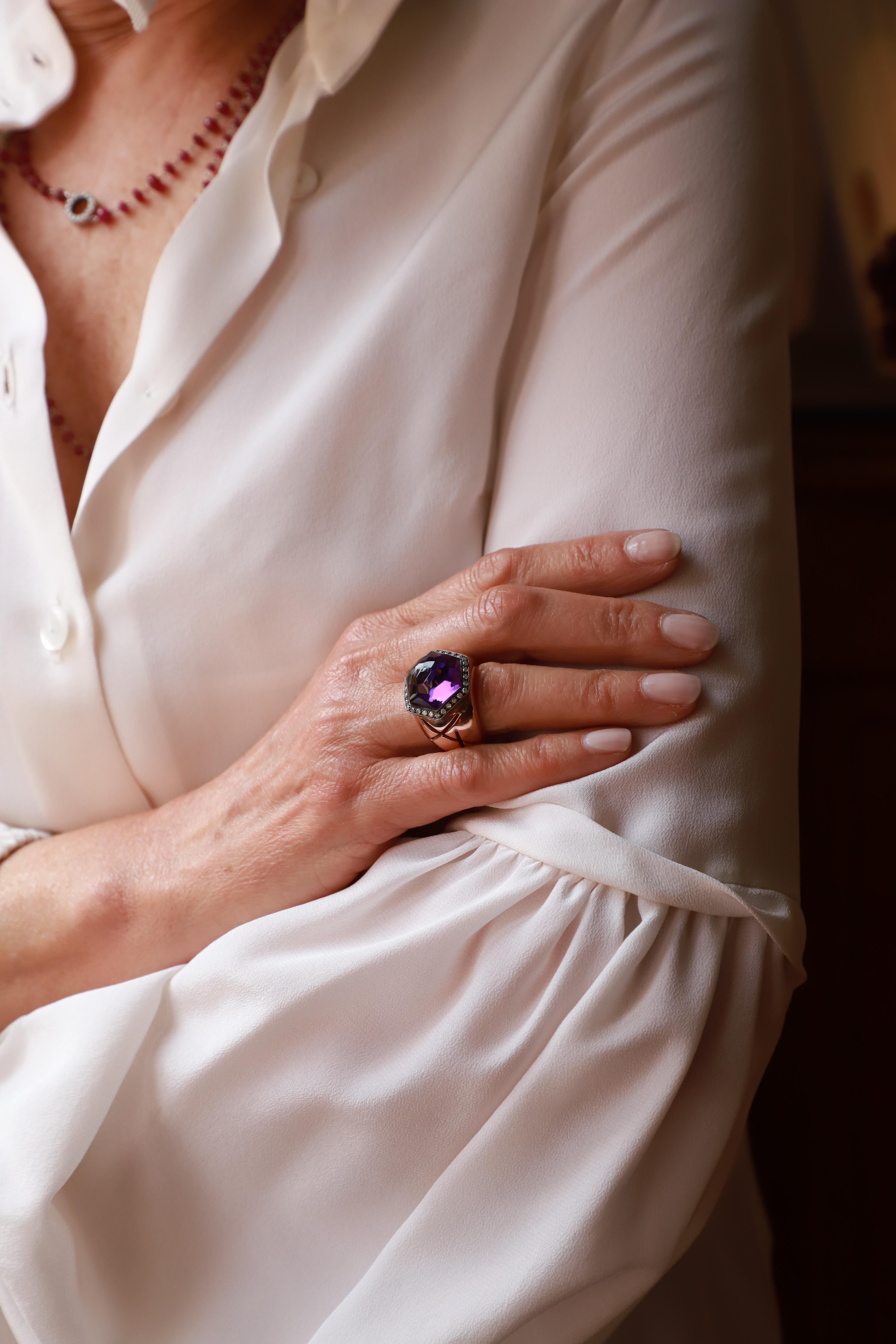 Indulge in the allure of the Rossella Ugolini Hexagonal Amethyst Cocktail Ring, a captivating statement piece handcrafted in 18k rose gold. The heart of the ring boasts a stunning Amethyst hexagonal cupola with a broilet cut, encircled by a graceful