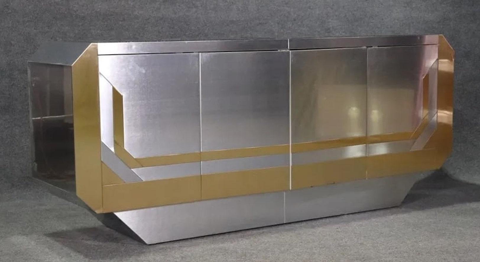 Vintage deco style credenza with chrome and brass plating. Three cabinets with adjustable shelves. Two mirrored panels on top.
Please confirm location NY or NJ