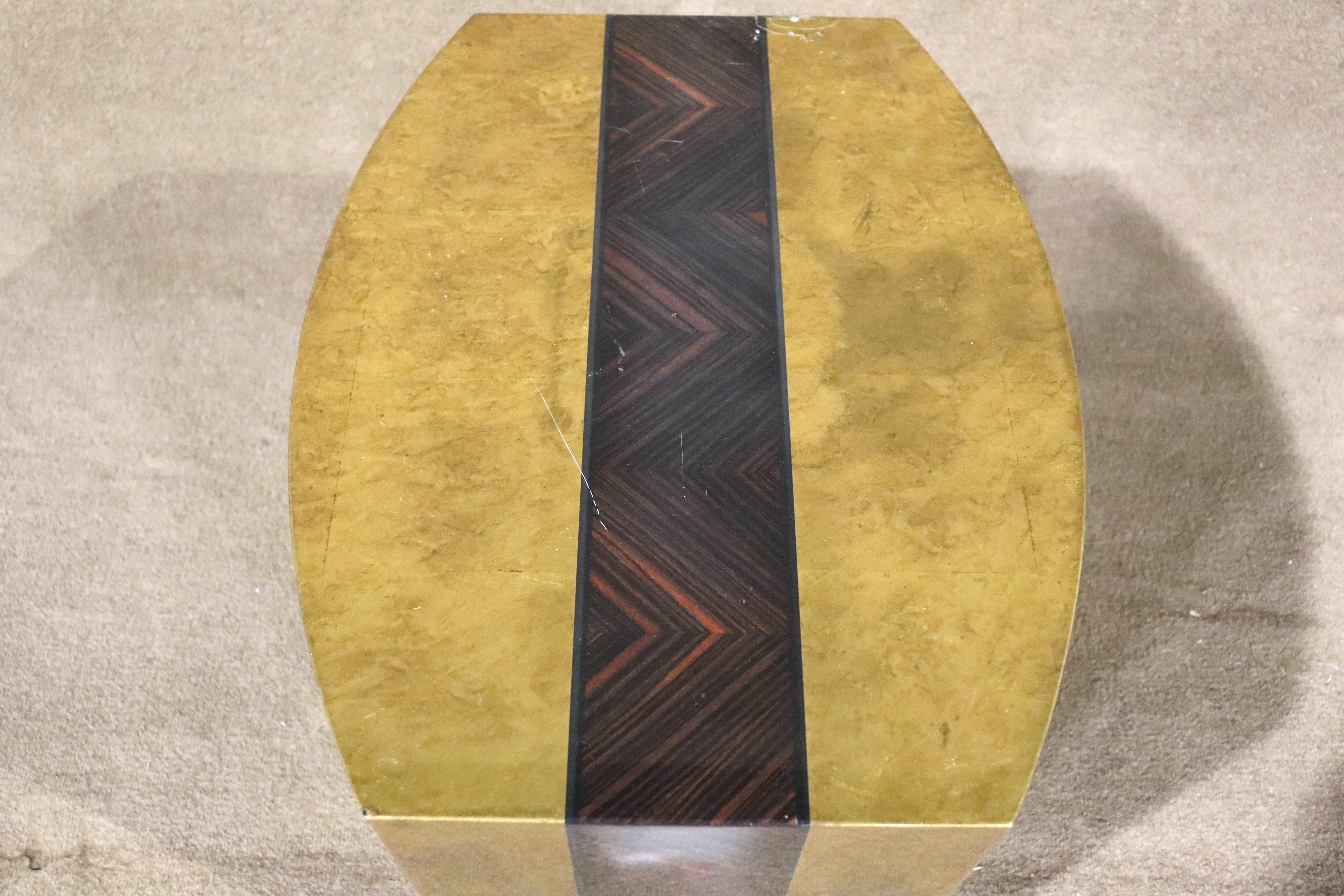 Small semi-oval table with patina brass colored lacquer and a stripe of rosewood grain. Great pop of color for your living room.
Please confirm location NY or NJ