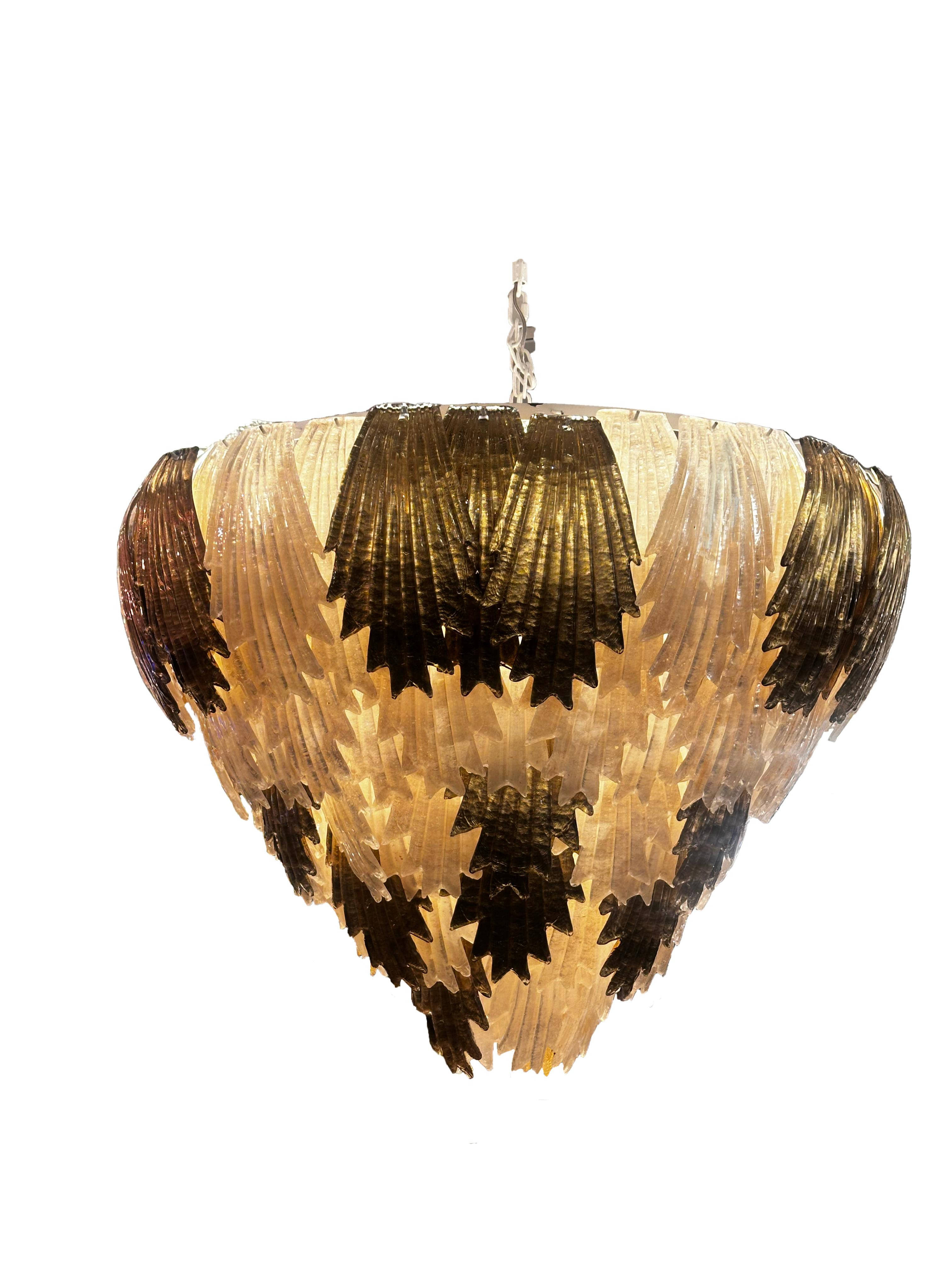 A luxurious and intricately designed Art Deco style chandelier of cascading, tiered  Murano glass leafs. Arranged in an alternating pattern of light and dark glass it creates a striking visual contrast. Meticulously constructed, it showcases a