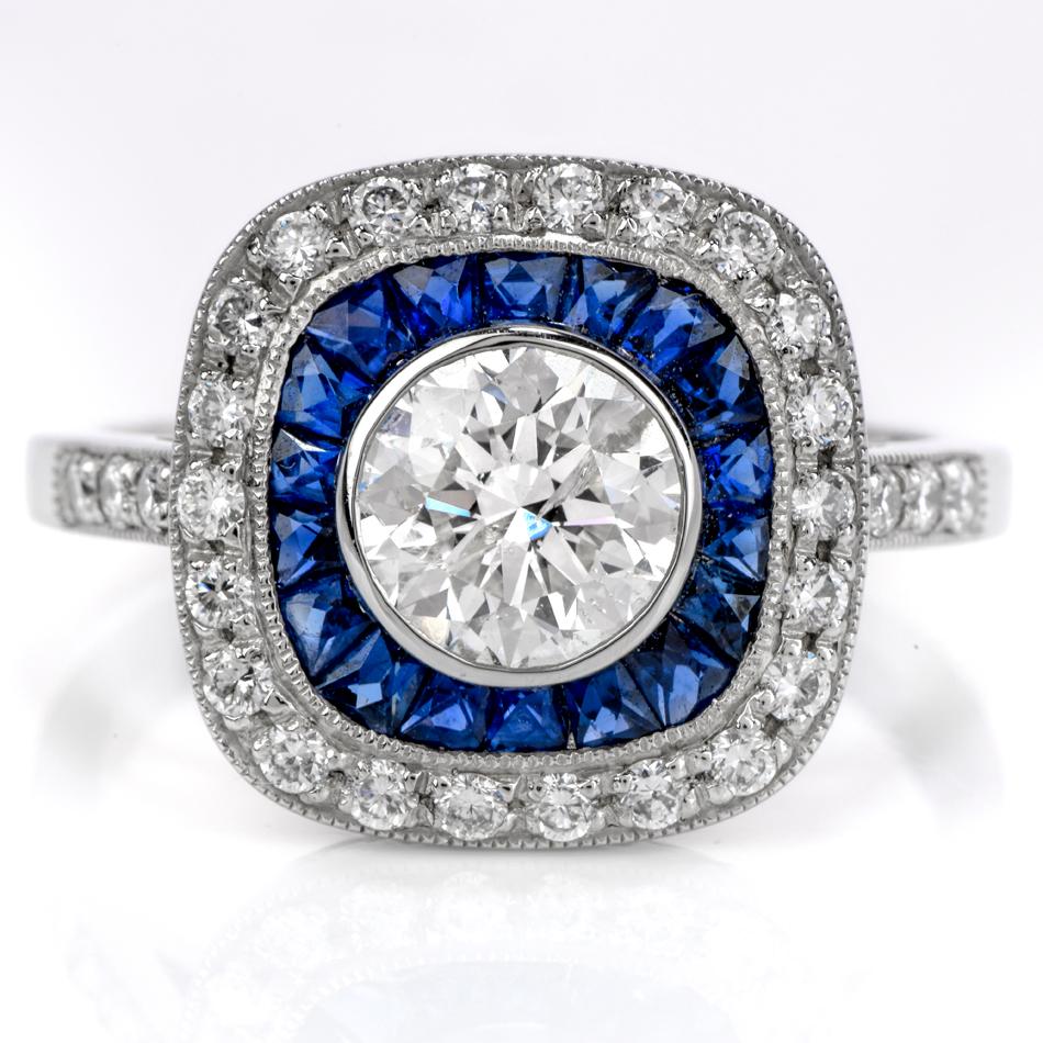 This Classoc art deco design diamond and blue sapphire flower engagement ring is crafted in platinum gold. Exposing a center bezel-set round-cut diamond weighing approx. 1.01 carats, graded G-H color, and SI2 clarity.

Embellished by a bezel-set
