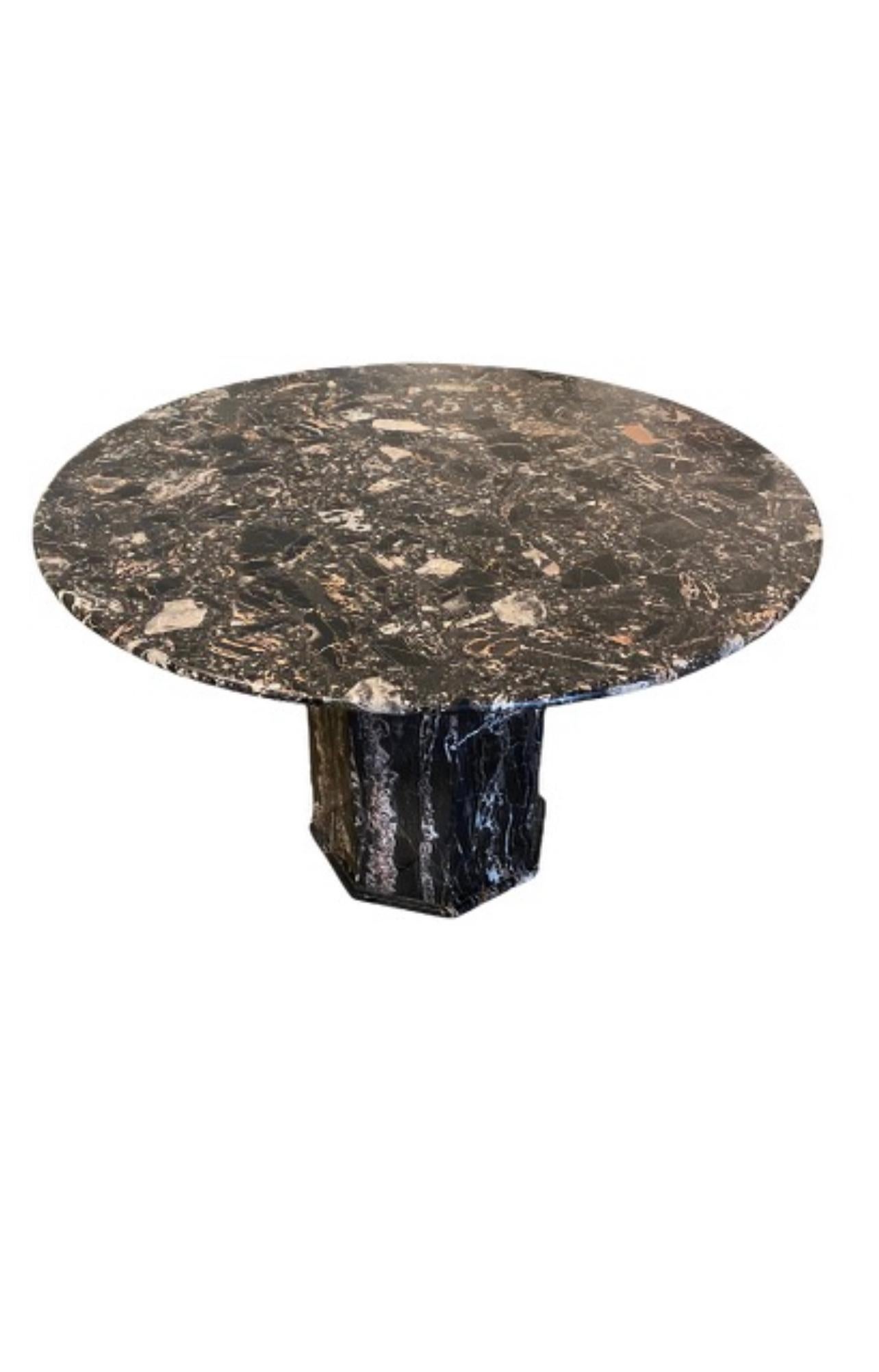 A center table in the of portoro marble 
Shades of black white and a beige/pink. Beautiful movement and coloration of the stone
Table has a modern deco feel..
The top seperates from the base for easier transport.