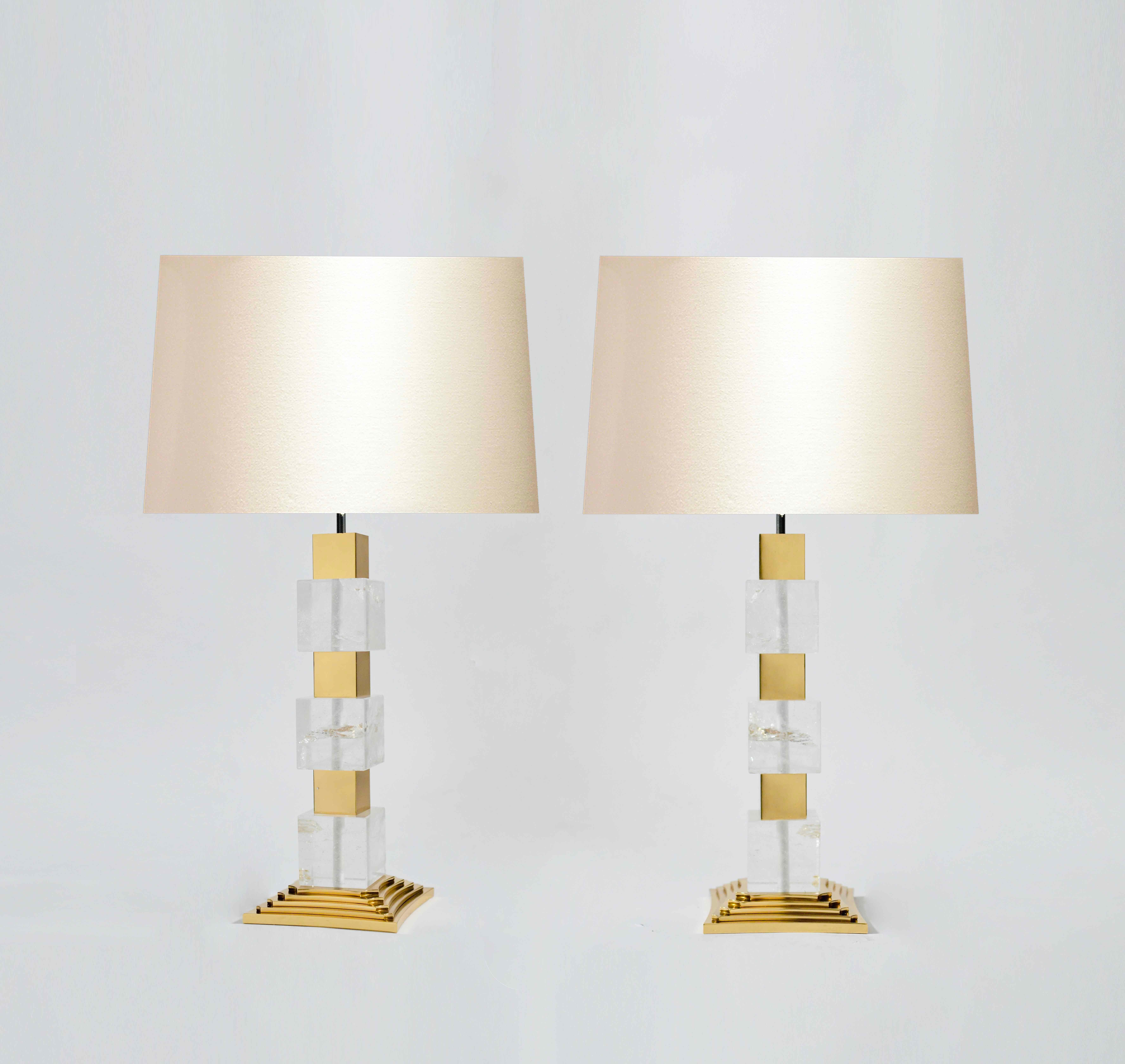 A pair of deco style rock crystal quartz lamps with polish brass inserts and bases, created by Phoenix Gallery, NYC.
To the rock crystal: 15 in/H.
(Lampshade not included).