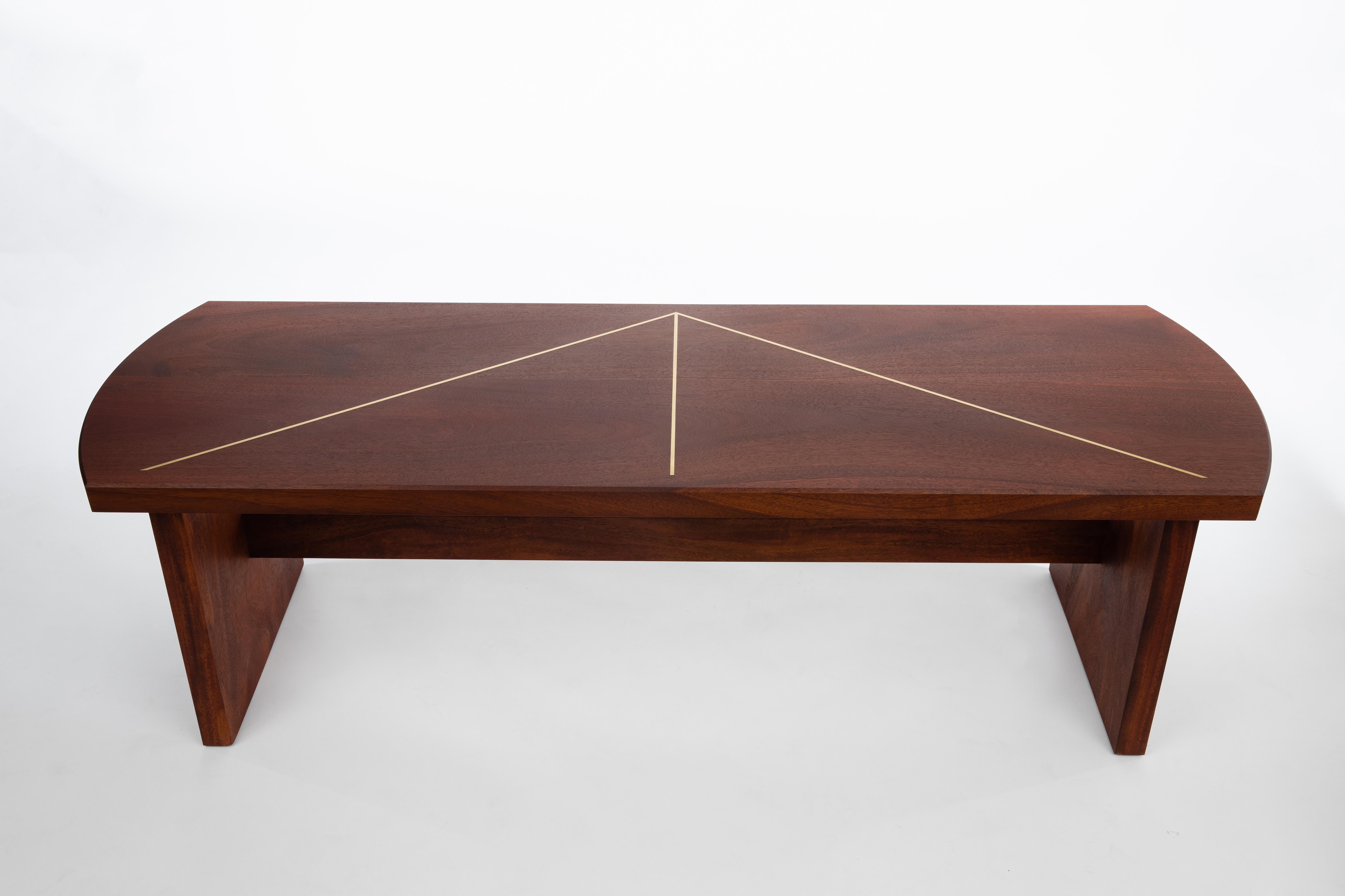 The Deco Table is made from solid, reclaimed Florida mahogany that was toppled during a hurricane. The streamlined top is inlaid with brass in an elegant deco motif. Every piece I make is unique. I work with a master woodworker to create each design