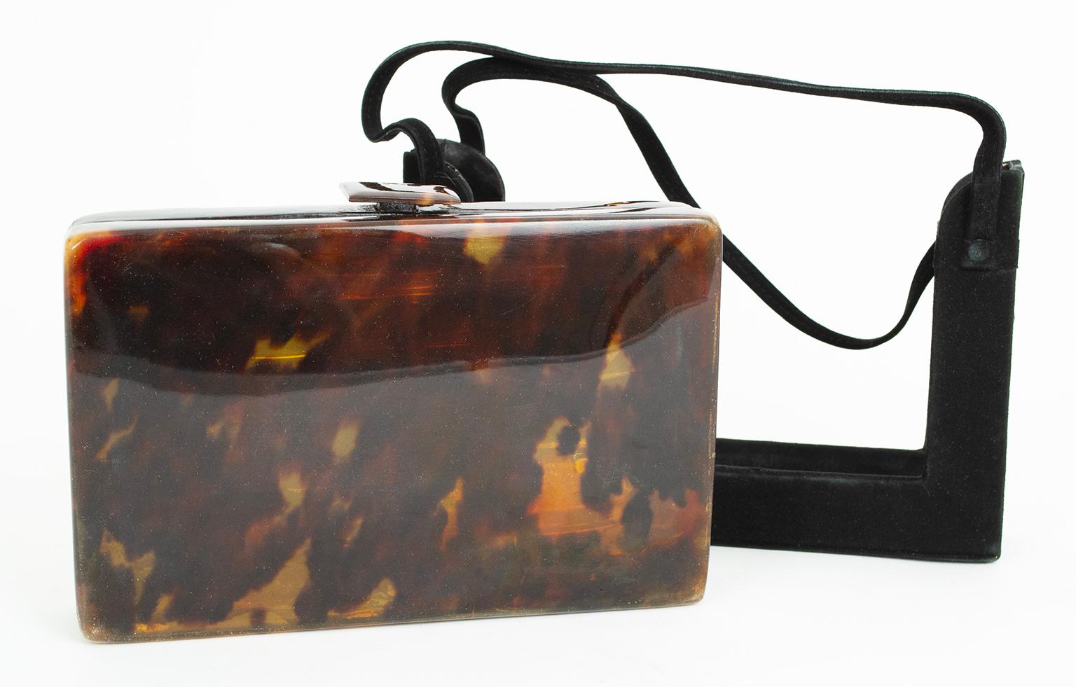 NOTE: THIS ITEM CAN ONLY BE SHIPPED TO ARIZONA ADDRESSES

As ingenious as it is rare and beautiful, this tortoiseshell clutch includes an open suede carrying sleeve that allows it to function as a top handle purse as well as a clutch. Featuring a
