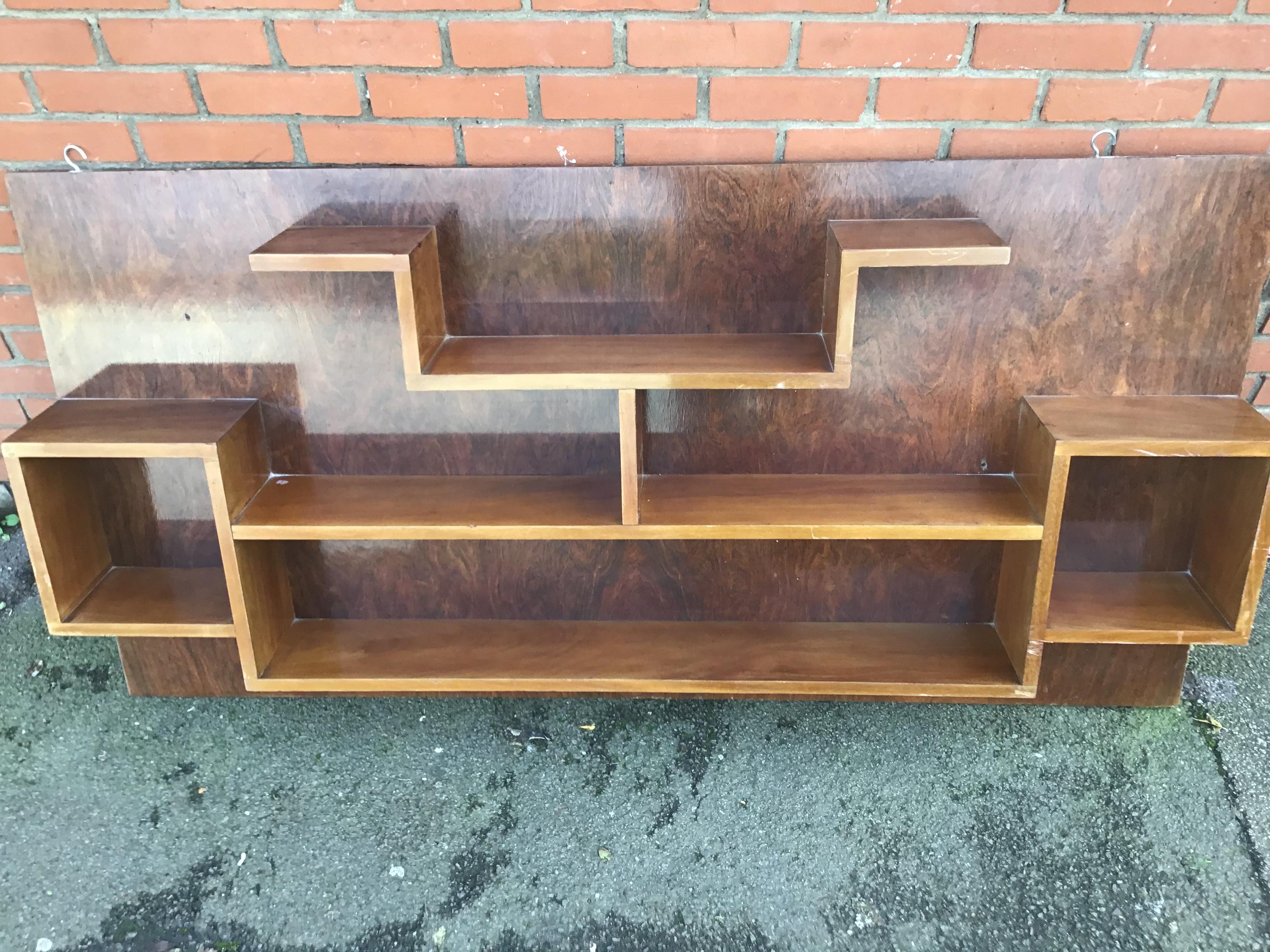 Unusual wall-mounted bookcase with walnut backing
French 1930-1940.