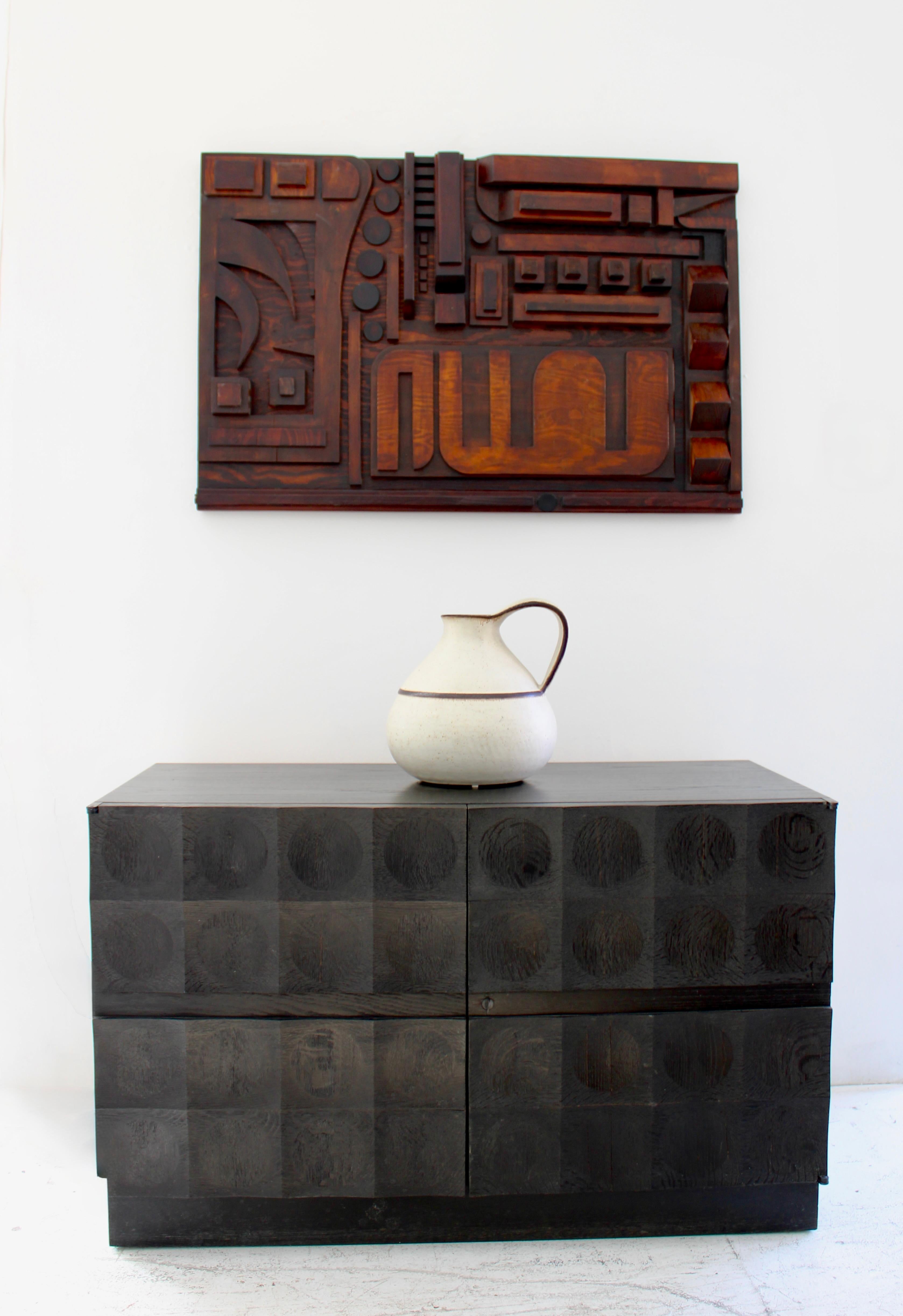 A DeCoene Freres blackened cerused oak small credenza with geometrically placed concave circles. Belgium c1970.