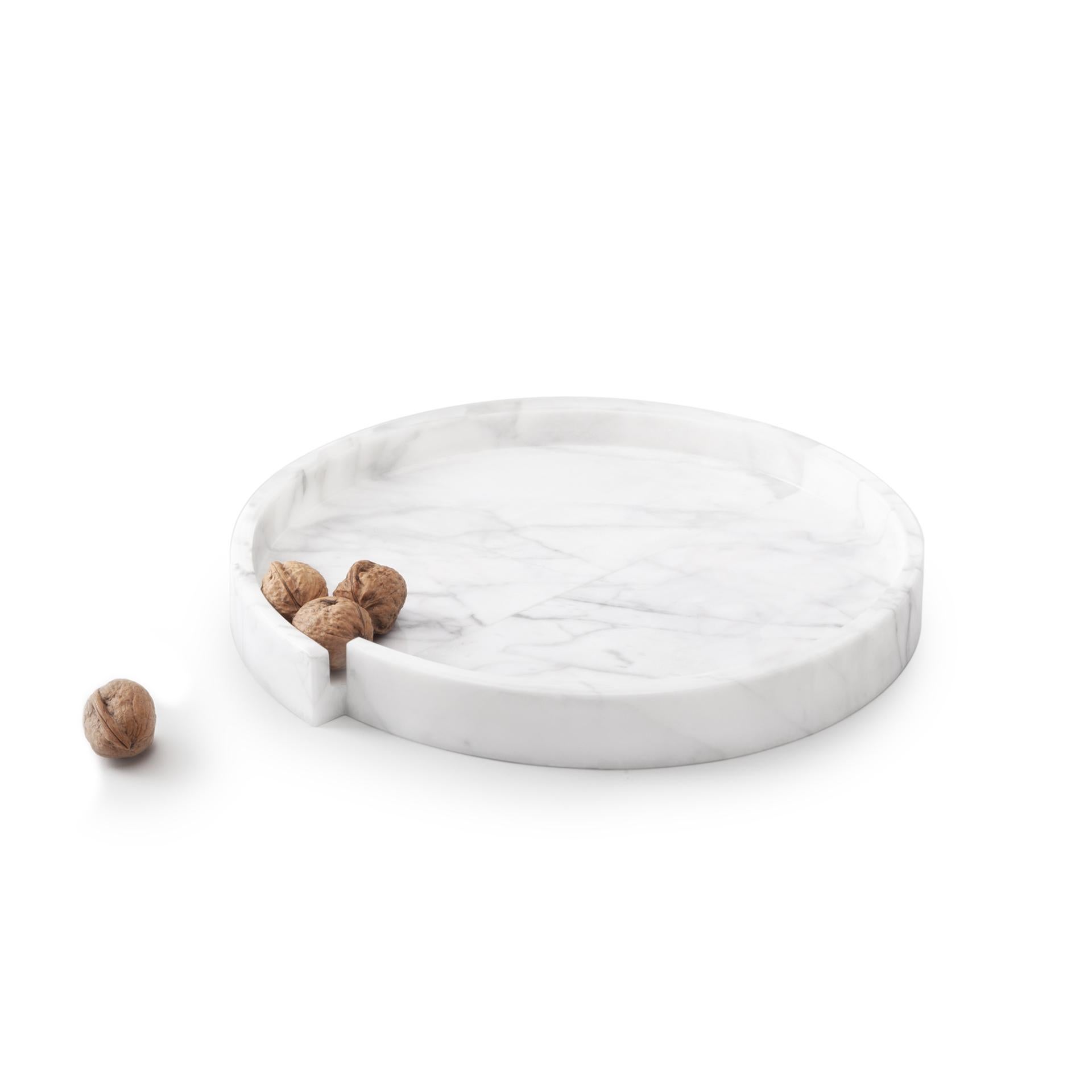 A playful and elegant marble tray made of two halves that appear to be matched incorrectly. The simplicity of the shape together with the choice of materials makes this a very versatile piece that can be used to add an understated detail to any