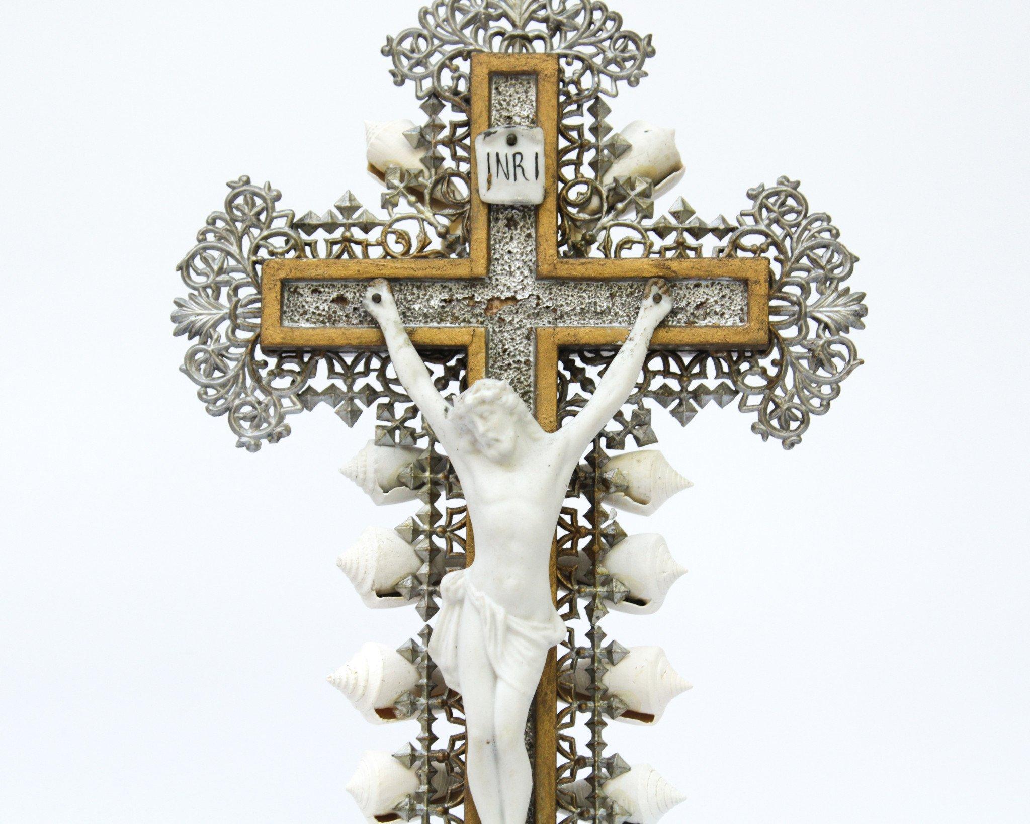 19th century French crucifix with metal filigree and a bisque corpus Christi decorated with fossil shells on Lucite.
