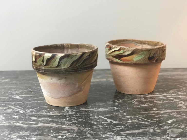Set of four decorated terra cotta and glazed rim pots in greens, blues and yellows from 1960s England. Can be individually sold. 