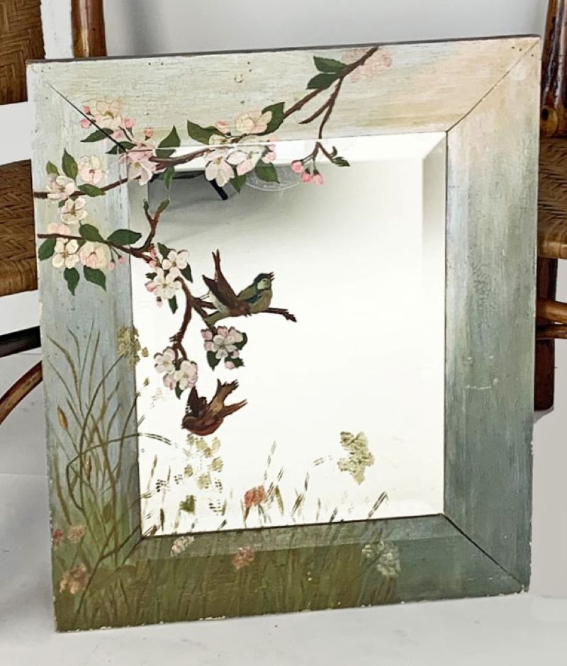 Decorated cottage mirror with beveled glass painted with birds and blossoms, circa 1890, measures 21.5” wide, 25.5” high. Condition is pristine.