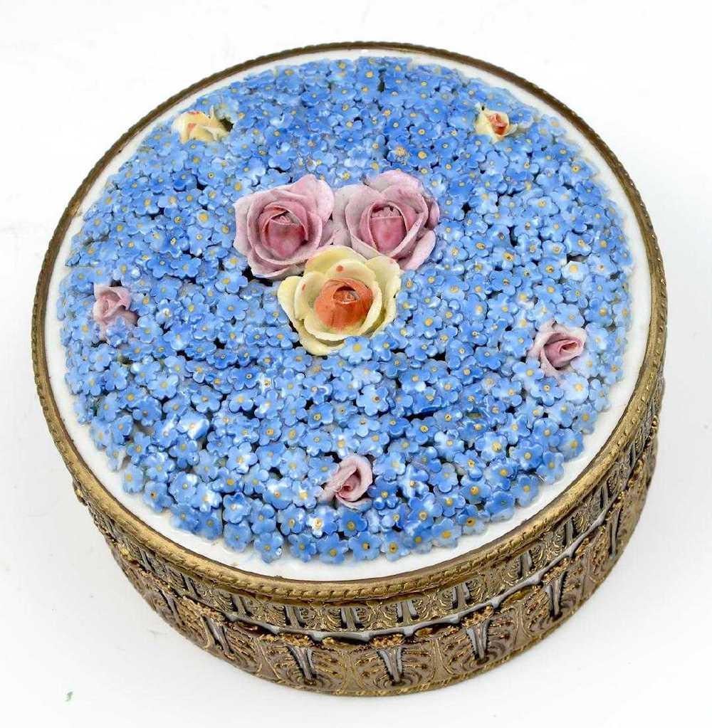 Covered forget-me-not porcelain box: circa 1900 porcelain box surmounted with forget-me-nots and roses attached in relief, with a hand painted floral and foliate motif, attached Gilt foliate design to lid and body encompassing, underside marked,