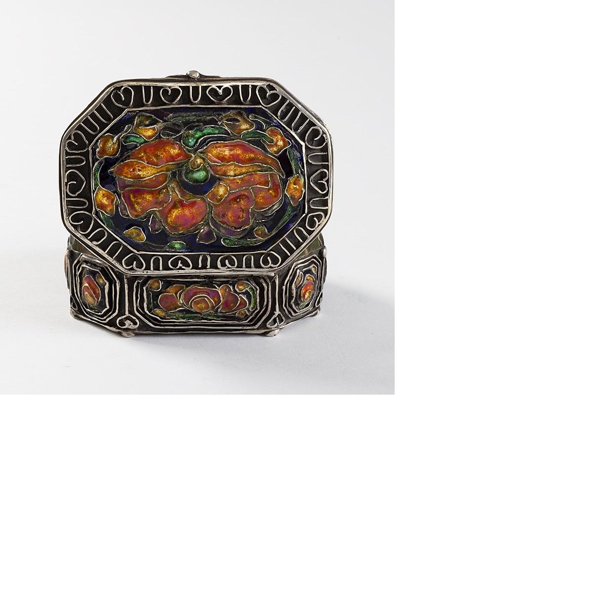 This delicately-scaled silver box, by master enamelist and metalsmith Elizabeth Copeland, is an Arts & Crafts collectible treasure. Consisting of refined Celtic-esque motifs in raised metalwork framing vignettes of soft, intricately-layered enamel